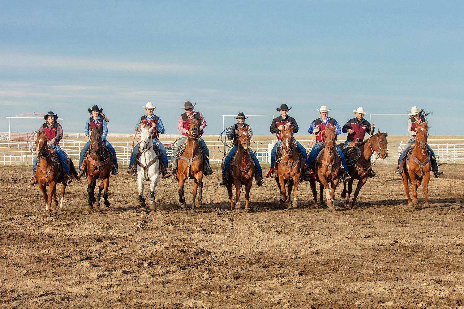 Members of the MSU-Northern rodeo team ride their horses together inside the rodeo ring at Box Elder, Montana.&nbsp;→ License Photo