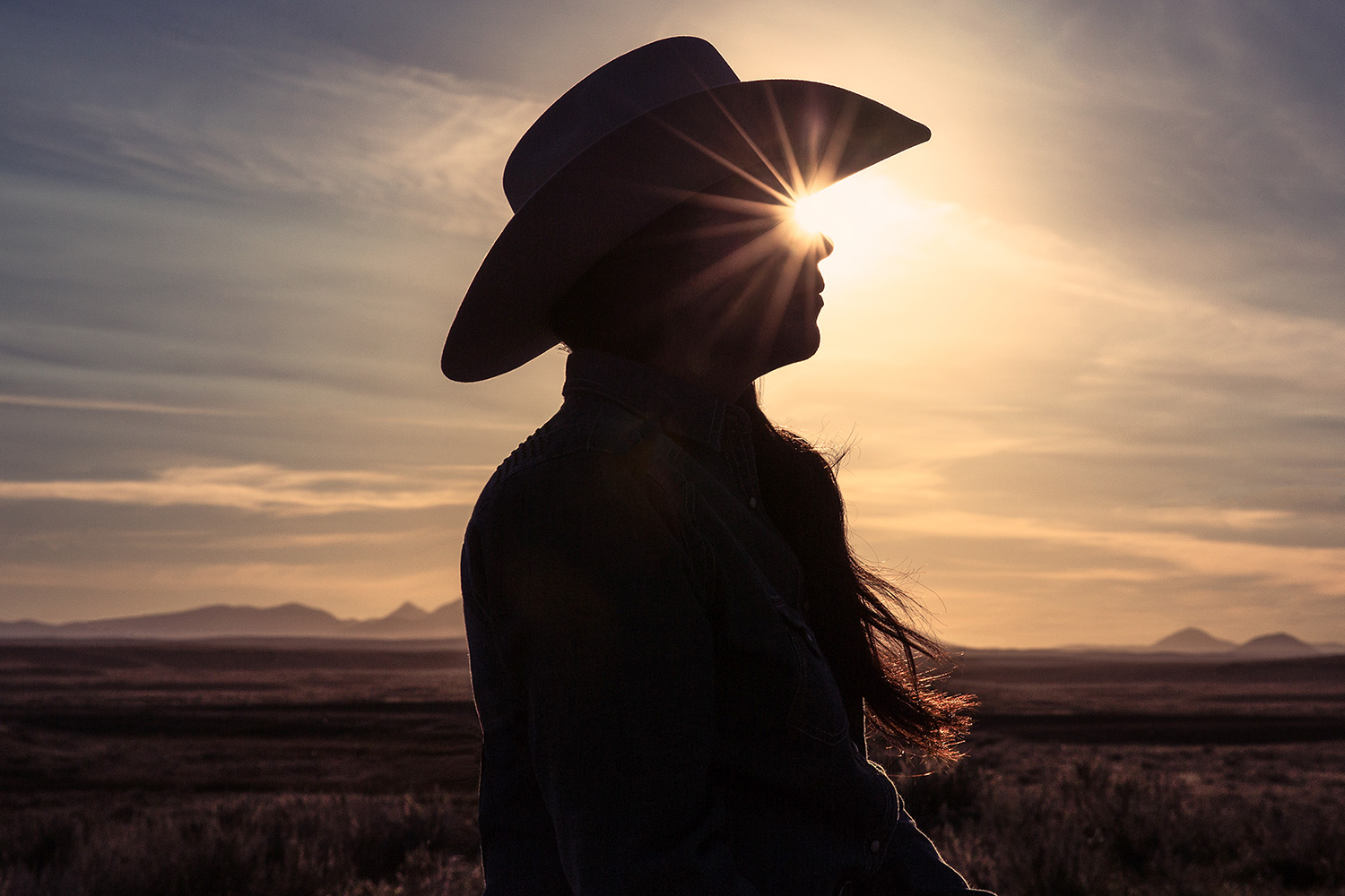 The sun shining through a cowgirl's eyes on a ranch near Fort Belknap, Montana.