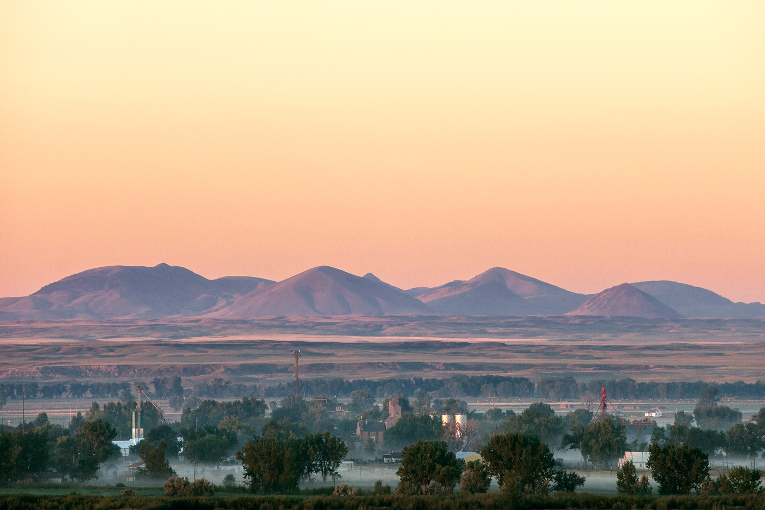 Fog drapes downtown Harlem, Montana with the Bear Paw Mountains looming large in the background.&nbsp;→ Buy a Print&nbsp;or License Photo