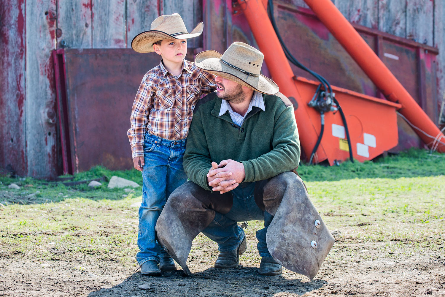 A cowboy father and son take a break from the action on a ranch near Chinook, Montana.&nbsp;→ License Photo