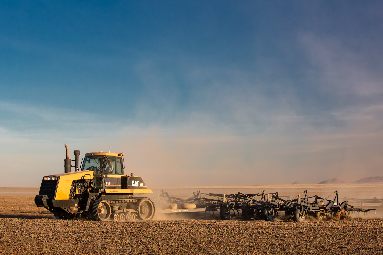 A Caterpillar tractor cultivating a field near Chinook, Montana.&nbsp;→ License Photo
