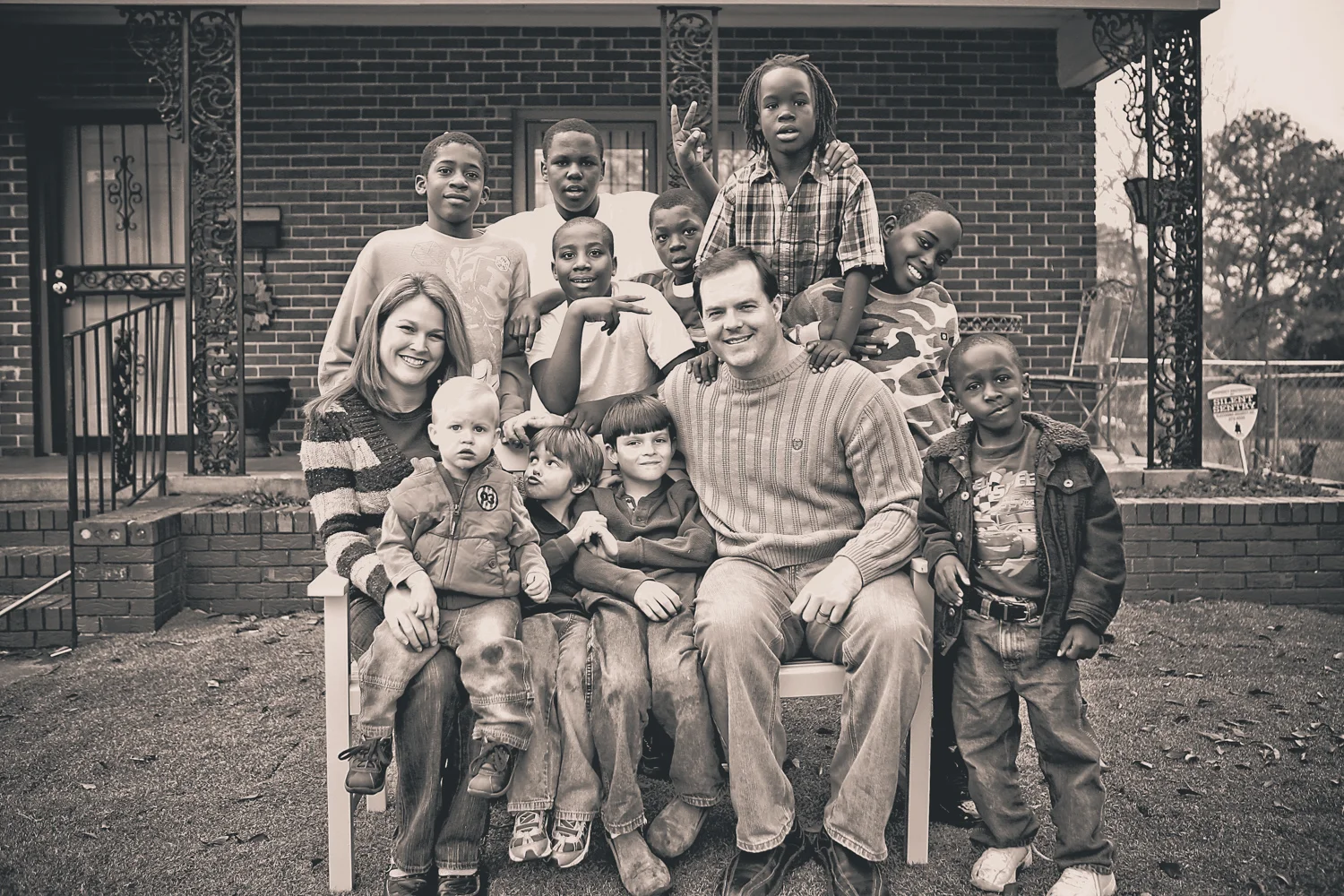 Founder Bryan Kelly and his wife, Delta, with their family and students from the neighborhood.