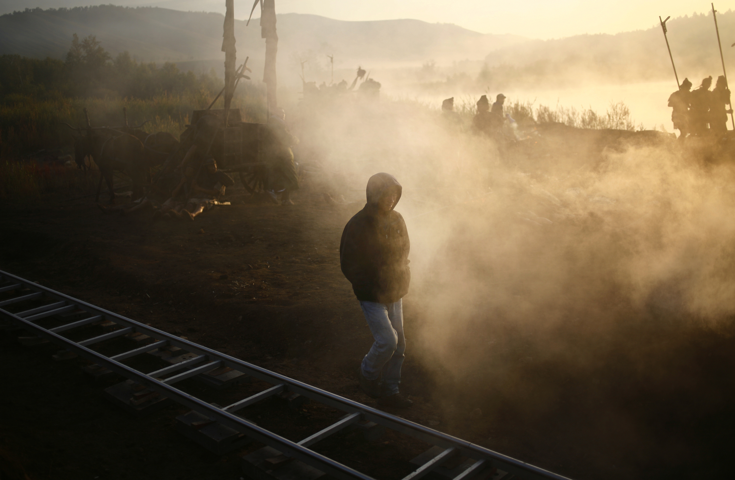 A crew member of a Chinese movie set walks down an on-location set in the early morning.