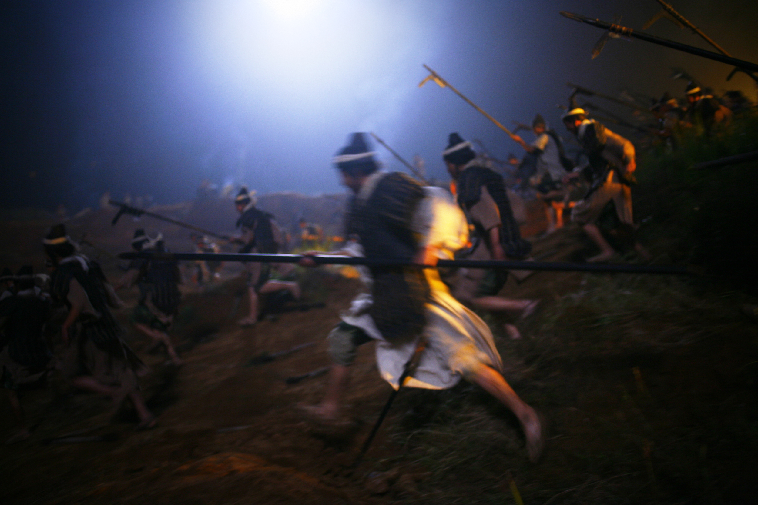 Extras practice a scene on location.
