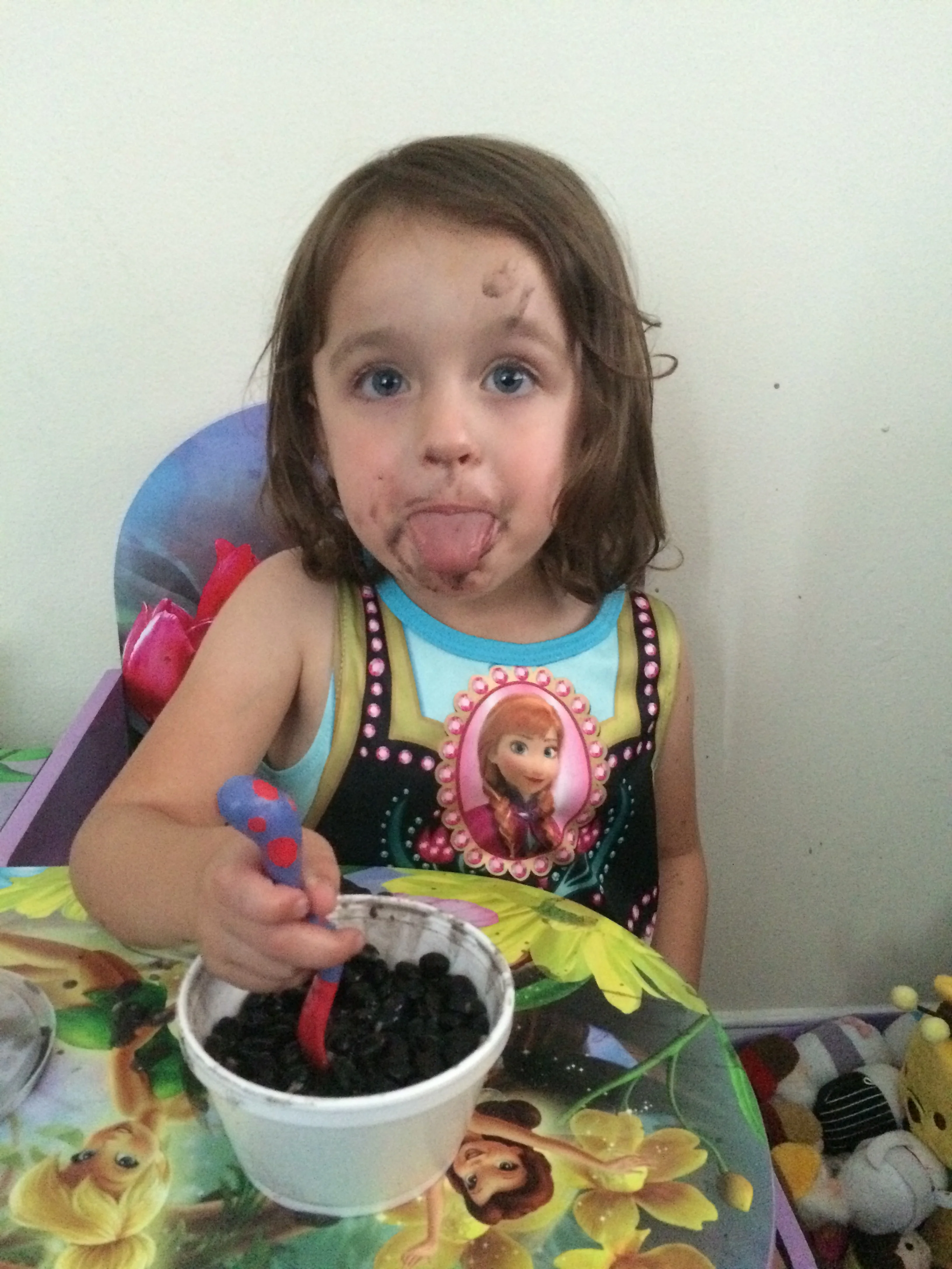 This picture doesn't allow you to appreciate the splattered black beans all over the wall behind her