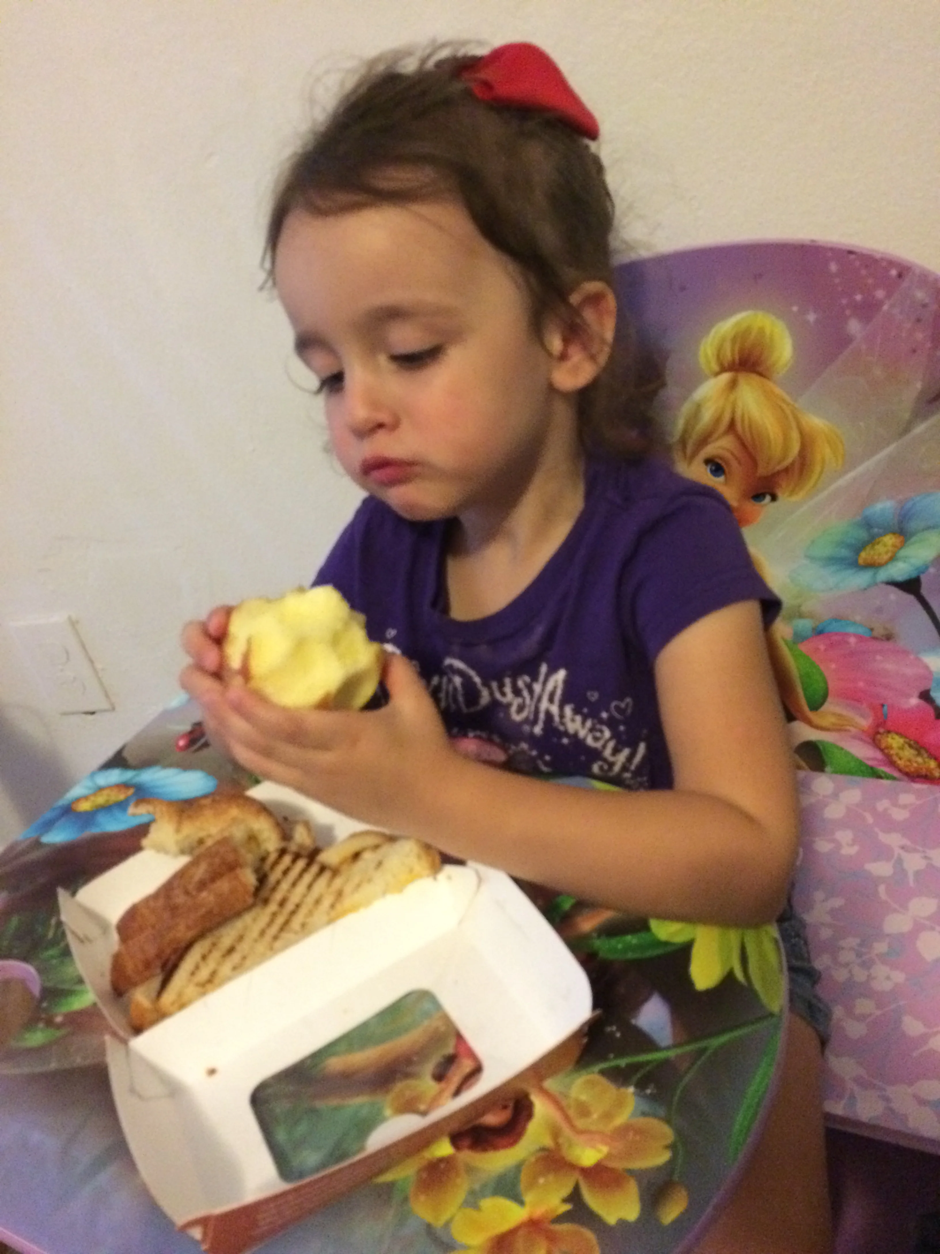 Daphne regarding her apple suspiciously