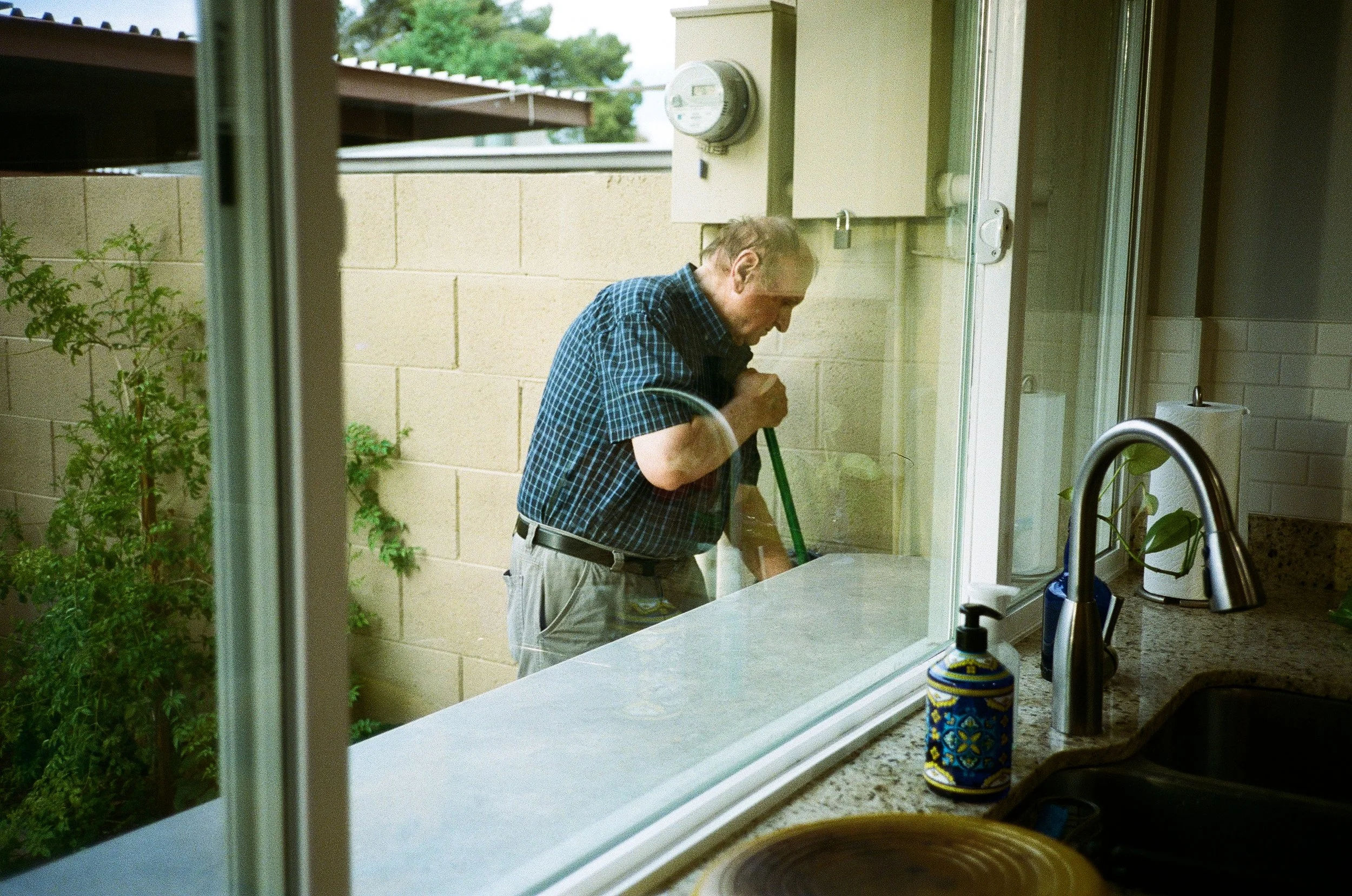 Daddy Sweeps The Patio
