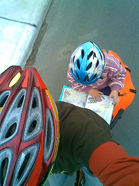 My daughter, Zoe, reading on the back of our Mighty Ute bicycle. 