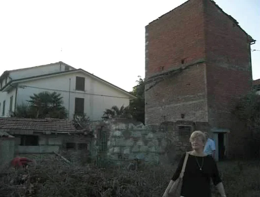 Grandma Rose in front of the barn her grandfather built