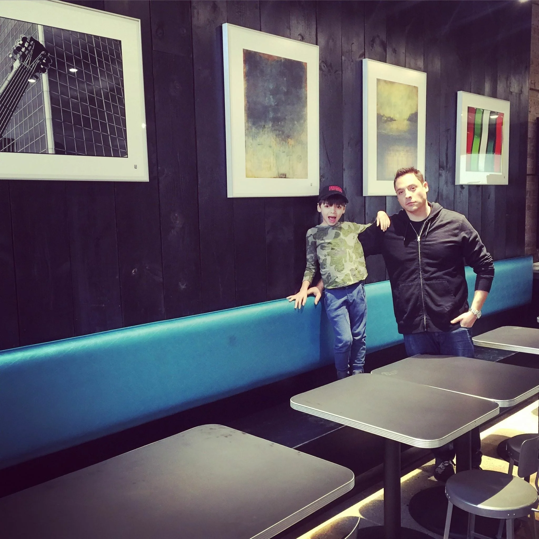 Jeff Mauro and his son Lorenzo standing in front of my two framed prints at Pork and Mindy's (repost from @jeffmauro)