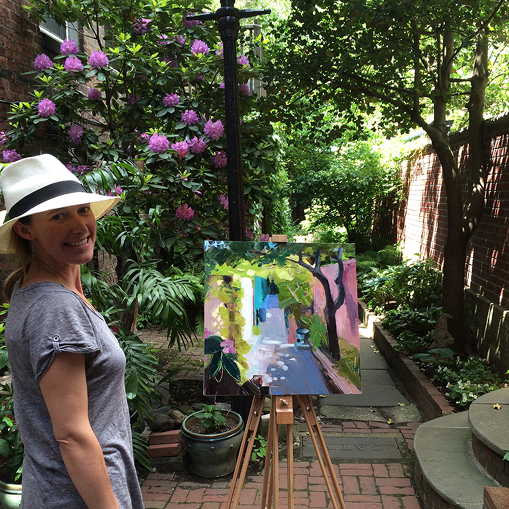Margaret Langford Sweet stands with her painting on the beautiful Lindall Court