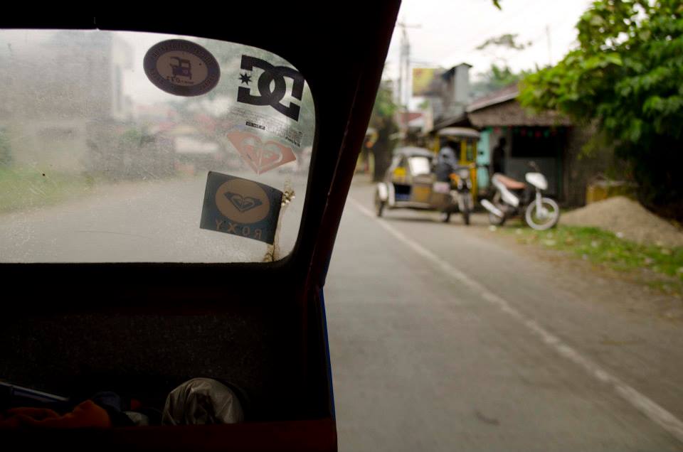 Peering out of the tricycle. Photograph by Lauren Migaki.