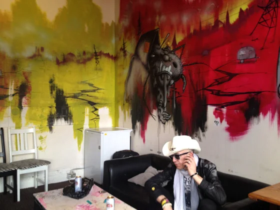 Rob backstage at Brixton Jamm, with a mural painted by a Banksy associate