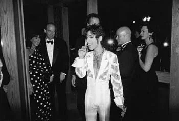 Kevin Sessums is to the right of Prince, critic Gene Siskel on the left…