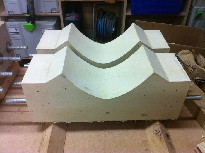 The concrete is taken out of the mould and left to dry further. The steel bolts running through are for strength but also to attach the curved oak leg uprights.