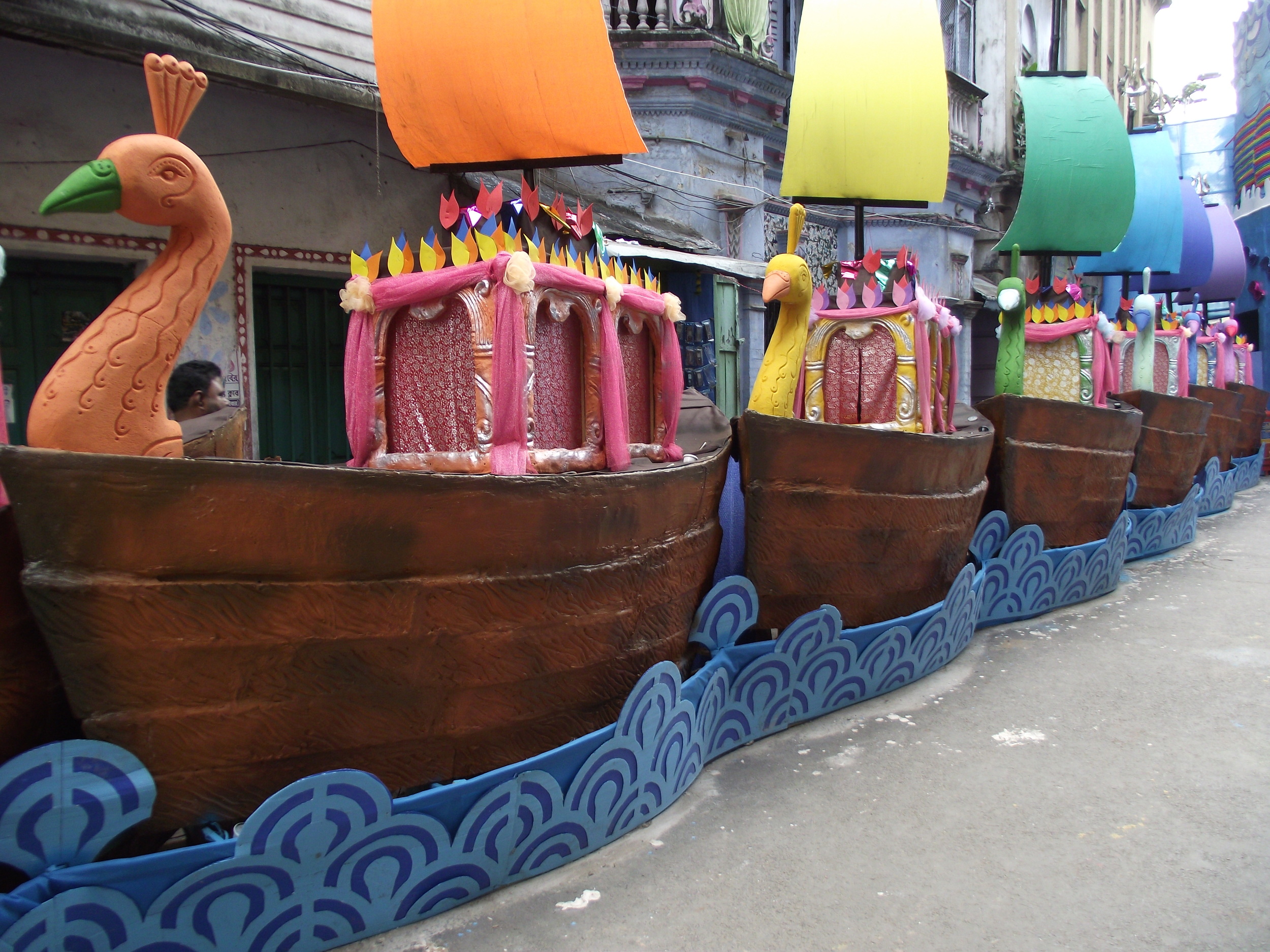  Colourful peacock faced boats (pokhhi raaj nouka) parked along the banks of the ocean 