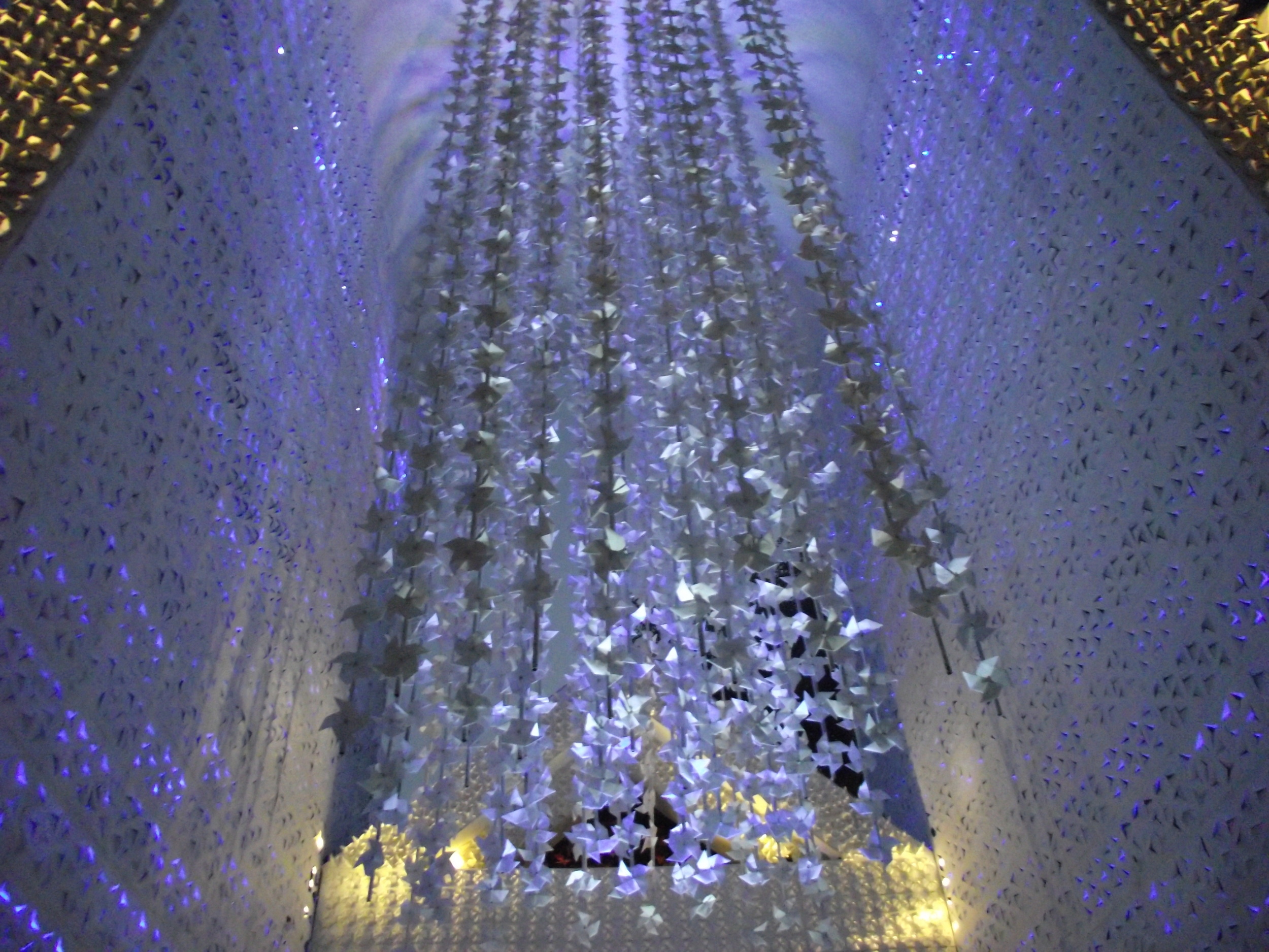  From the ceiling of the pandal were flowing long strings of silver paper origami. The atmosphere was that of a silver spring waterfall. 