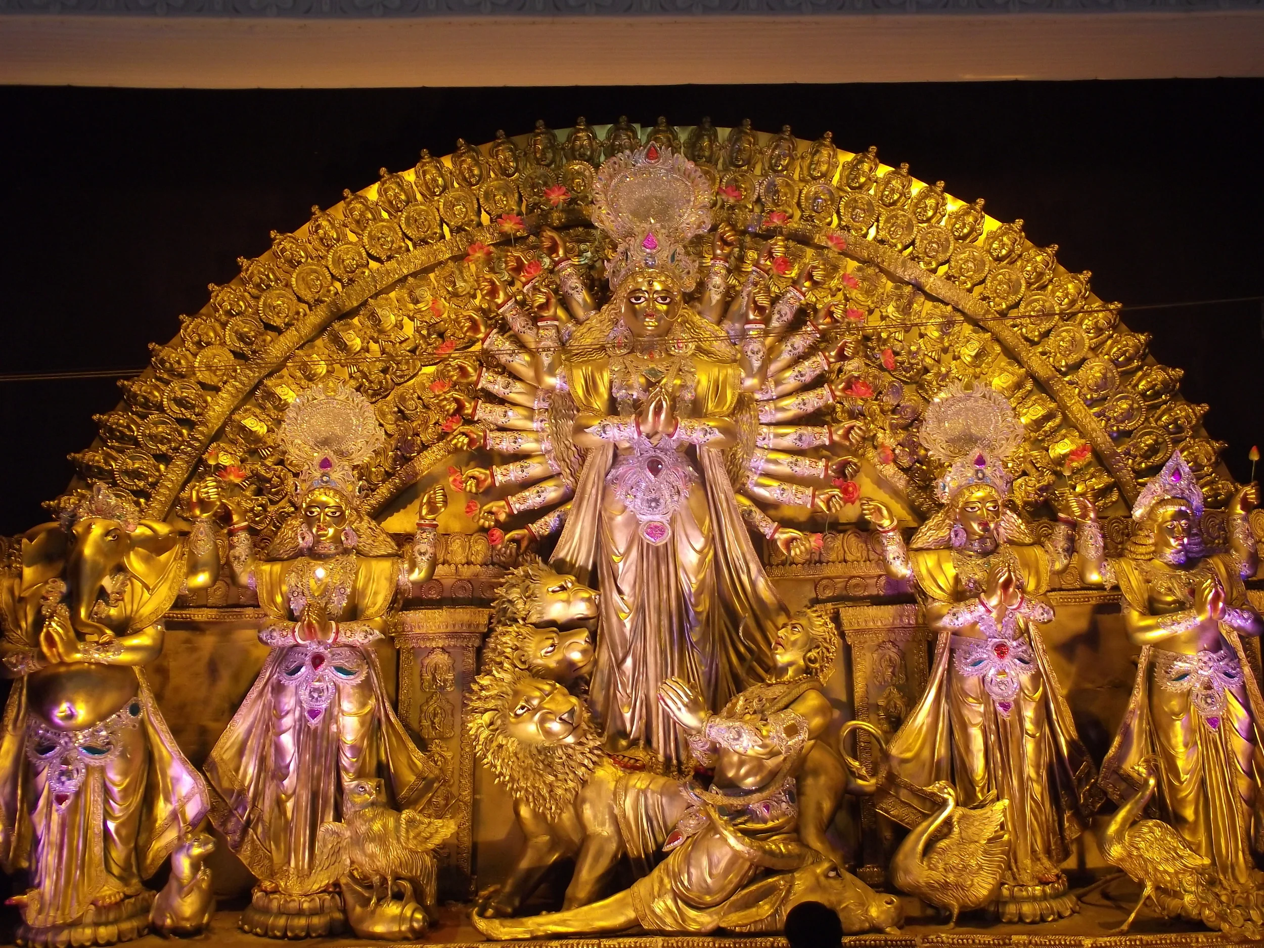  Golden Durga with a shining metal finish. The artist has imagined 20 hands instead of 10! 