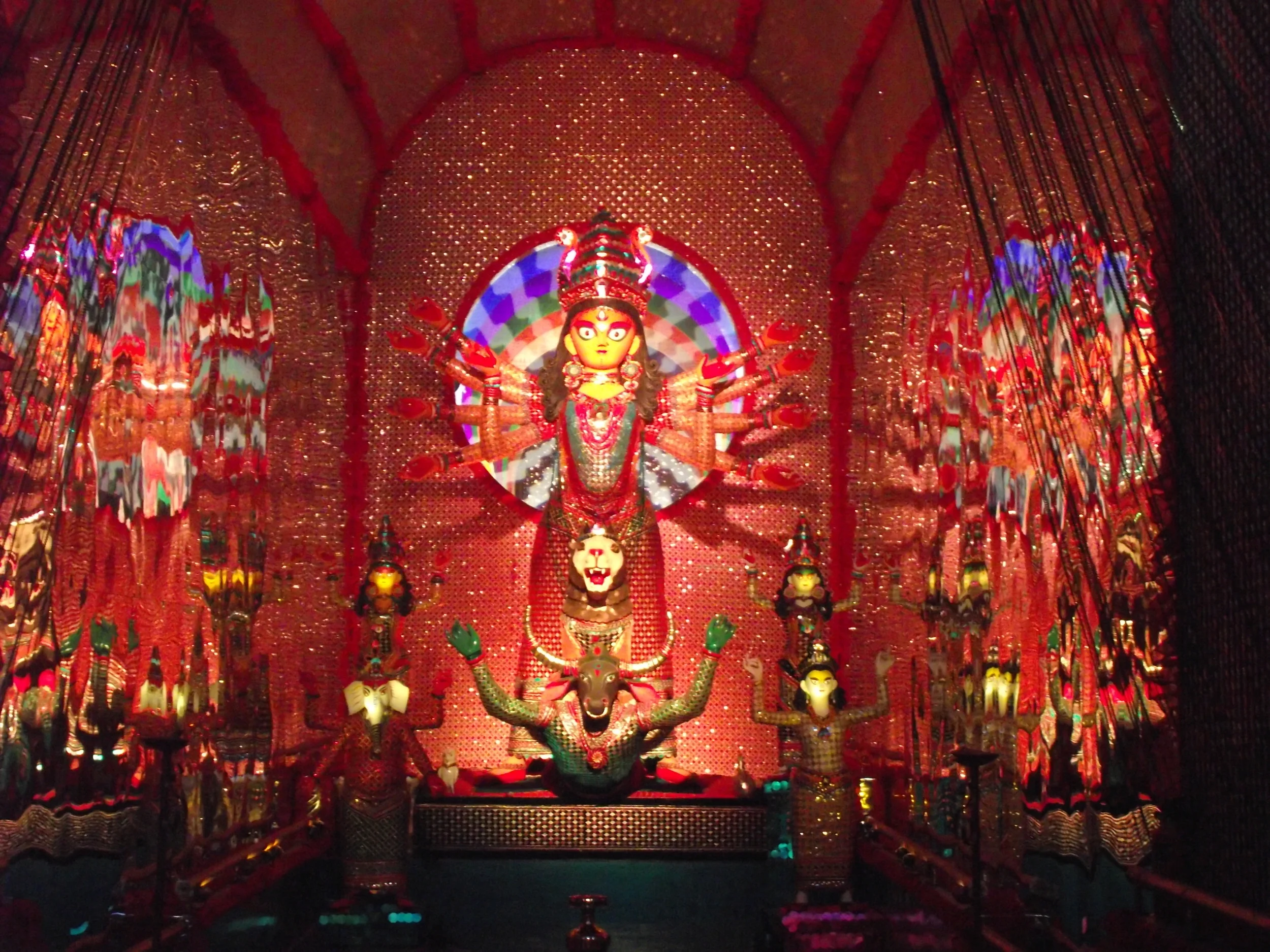  In the centre of the pandal are devi Durga,&nbsp;her four kids and asura who are also an equal party to this "Festival of Happiness". They have spread their arms in response to the vibrant music. 