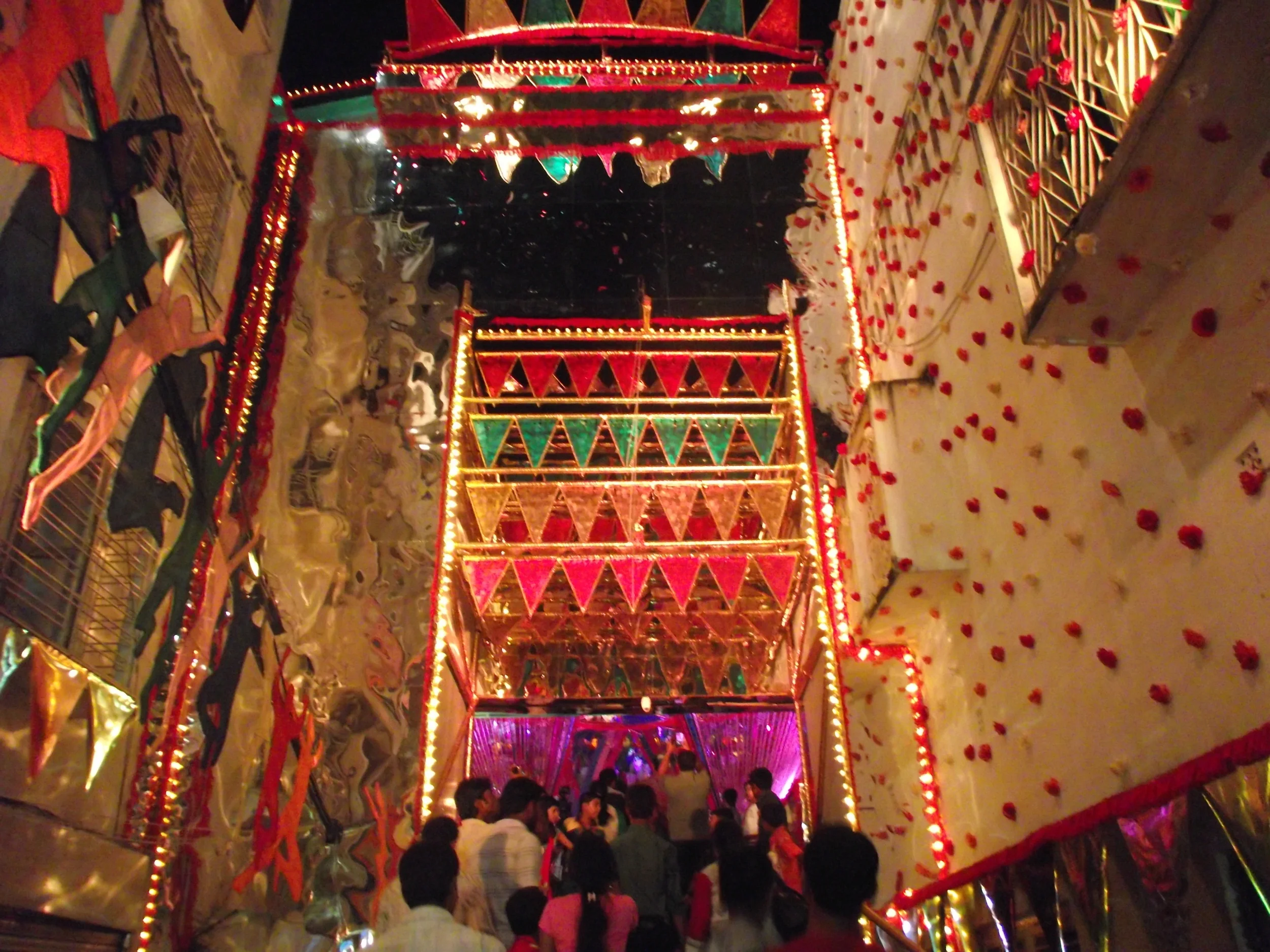  Entrance to Pallysree. Trademark Sushanta Paul style - observe the way he has used the buildings in both sides of the road and incorporated them as part of the pandal. The moment one entered this area he was greeted with a lively happy music created