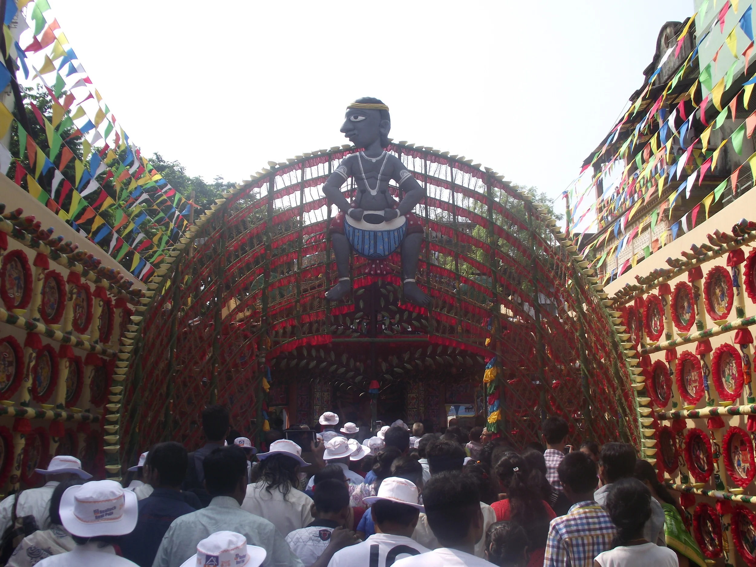  Everybody getting a musical welcome.   A slightly different perspective:   In this image you will see a lot of spectators wearing white hats. These were all senior citizens. A travel group along with a NGO had arranged these tours for senior citizen