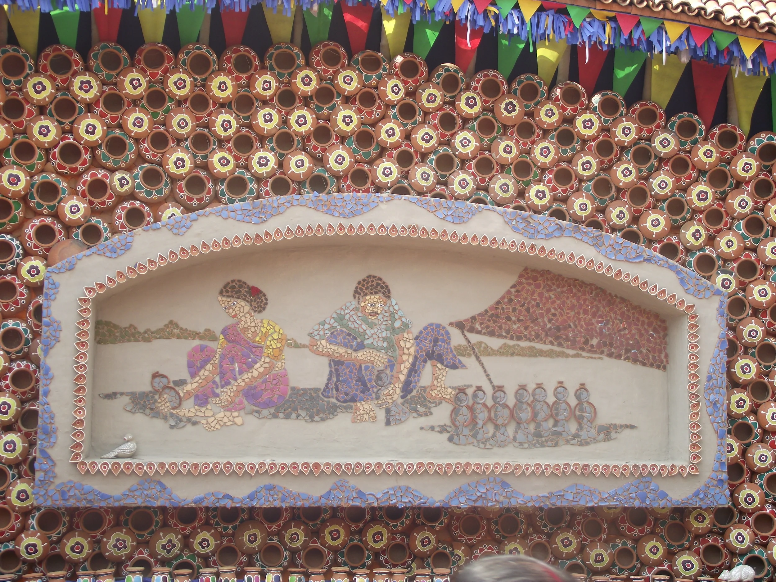  The outside premises were a tribute to the life of craftsmen who have mastered the art of clay modeling and terracotta. Here is one such frame showing a couple making clay dolls 