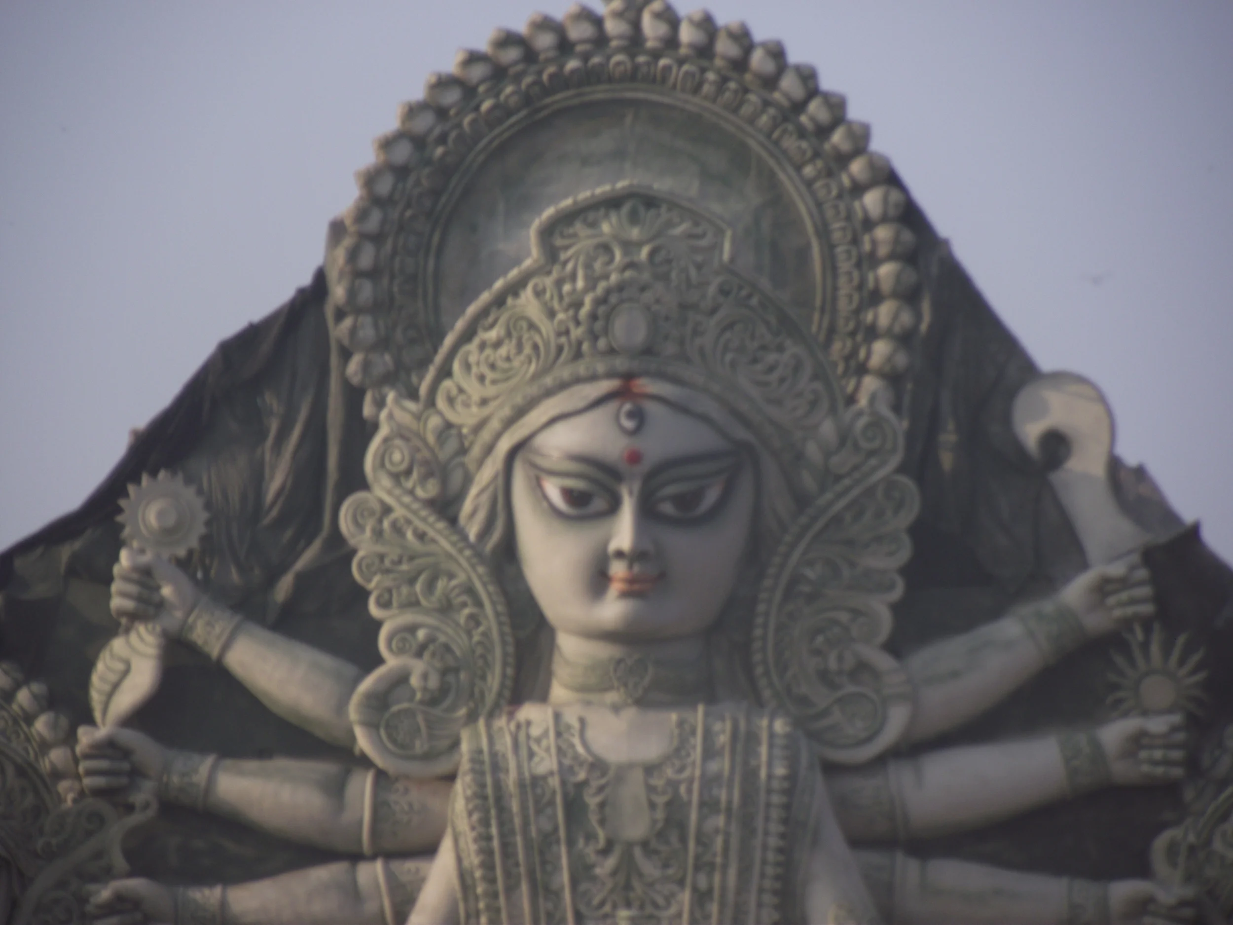  Close up shot of Maa Durga's face. The idol had a limestone finish with a light green tinge. It looked like a sculpture from a distance. 