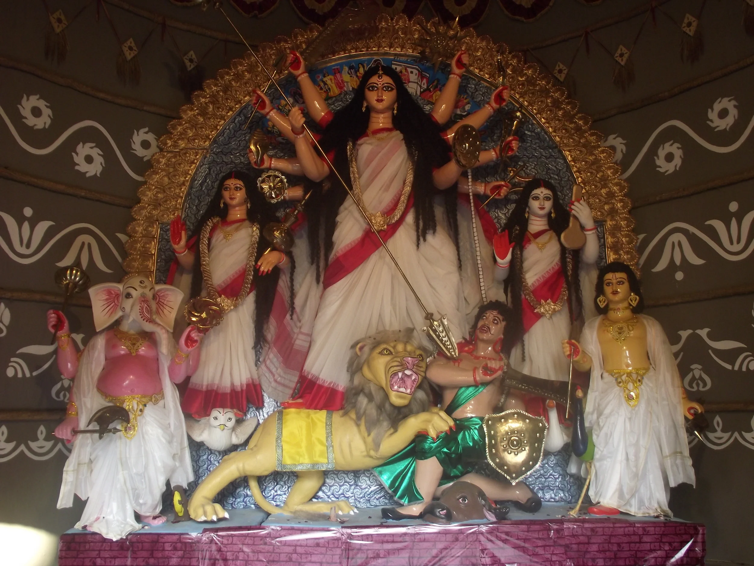  Simplicity of idol in laalpaar saree. Observe the neat aalponas (patterns) on the walls. 