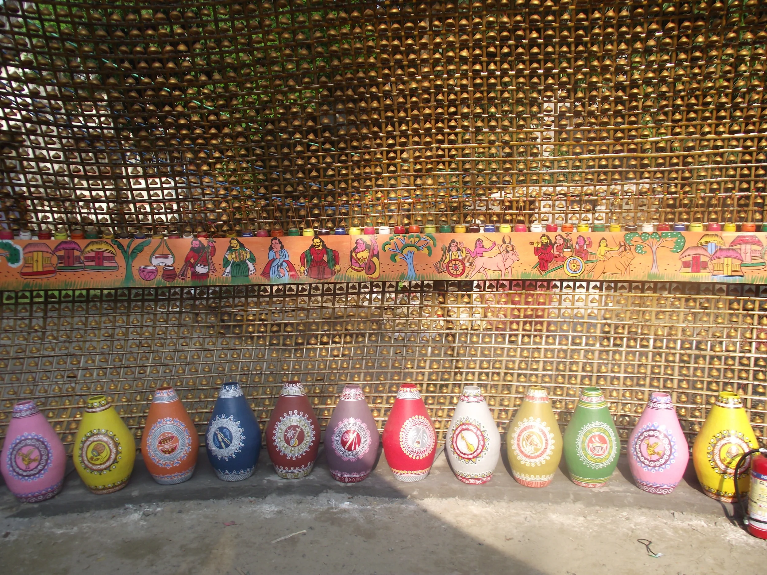  Series of colourful drums arranged symmetrically along the circumference of the wall of the pandal. 