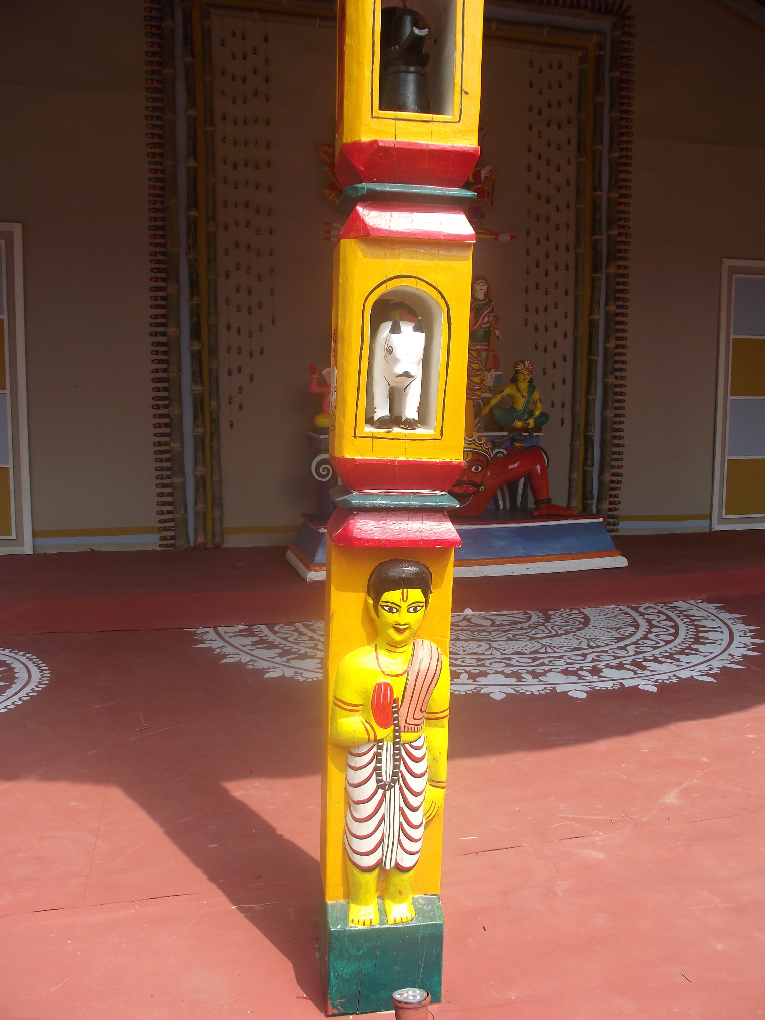  The pillars were carved out with care with images from rural life. Notice the intricate  alpana  in the platform. 