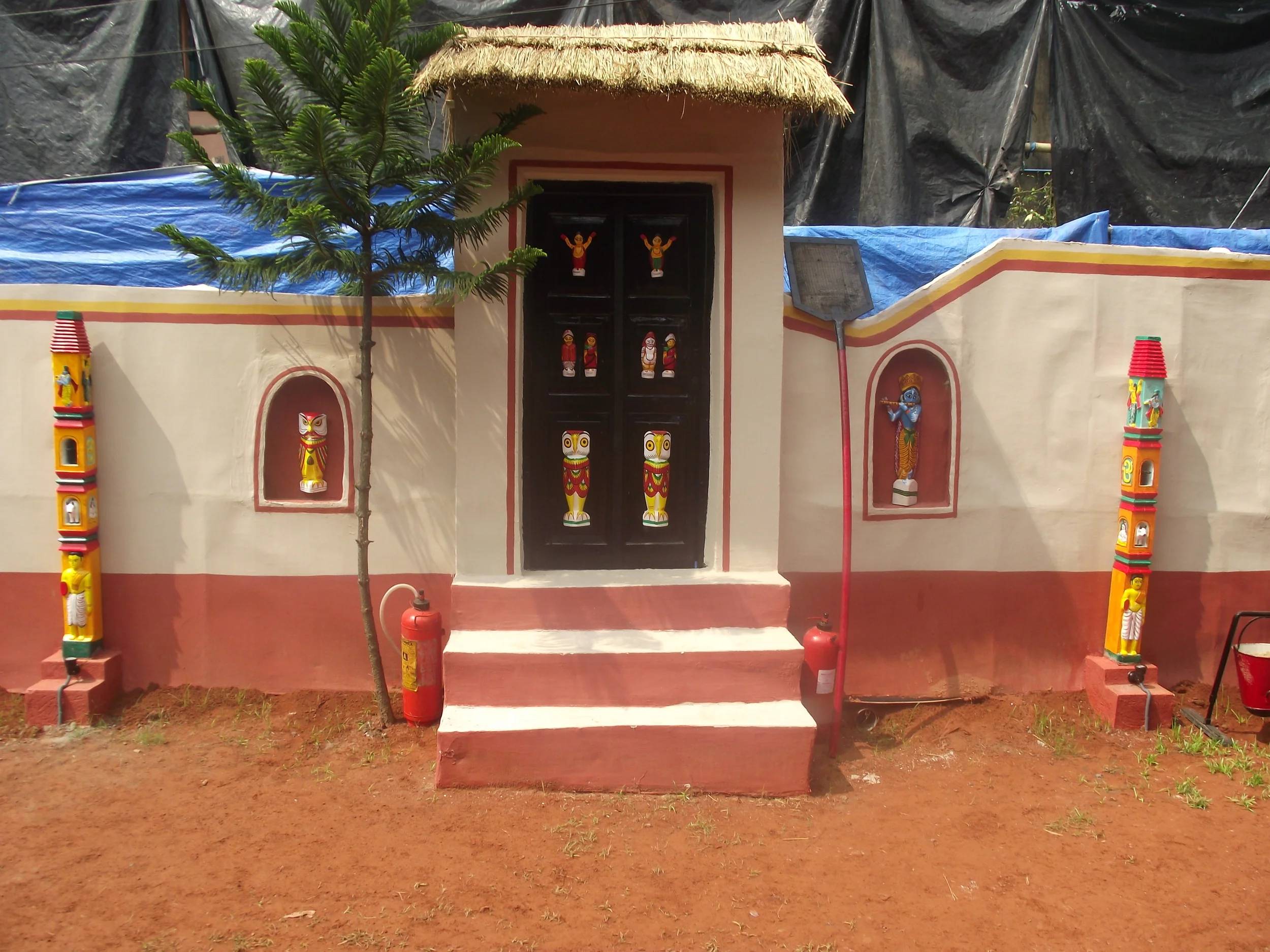  The side walls of the pandal. It was a rural set up with huts and doors to entry. But one thing that was common was  kaath putul . 