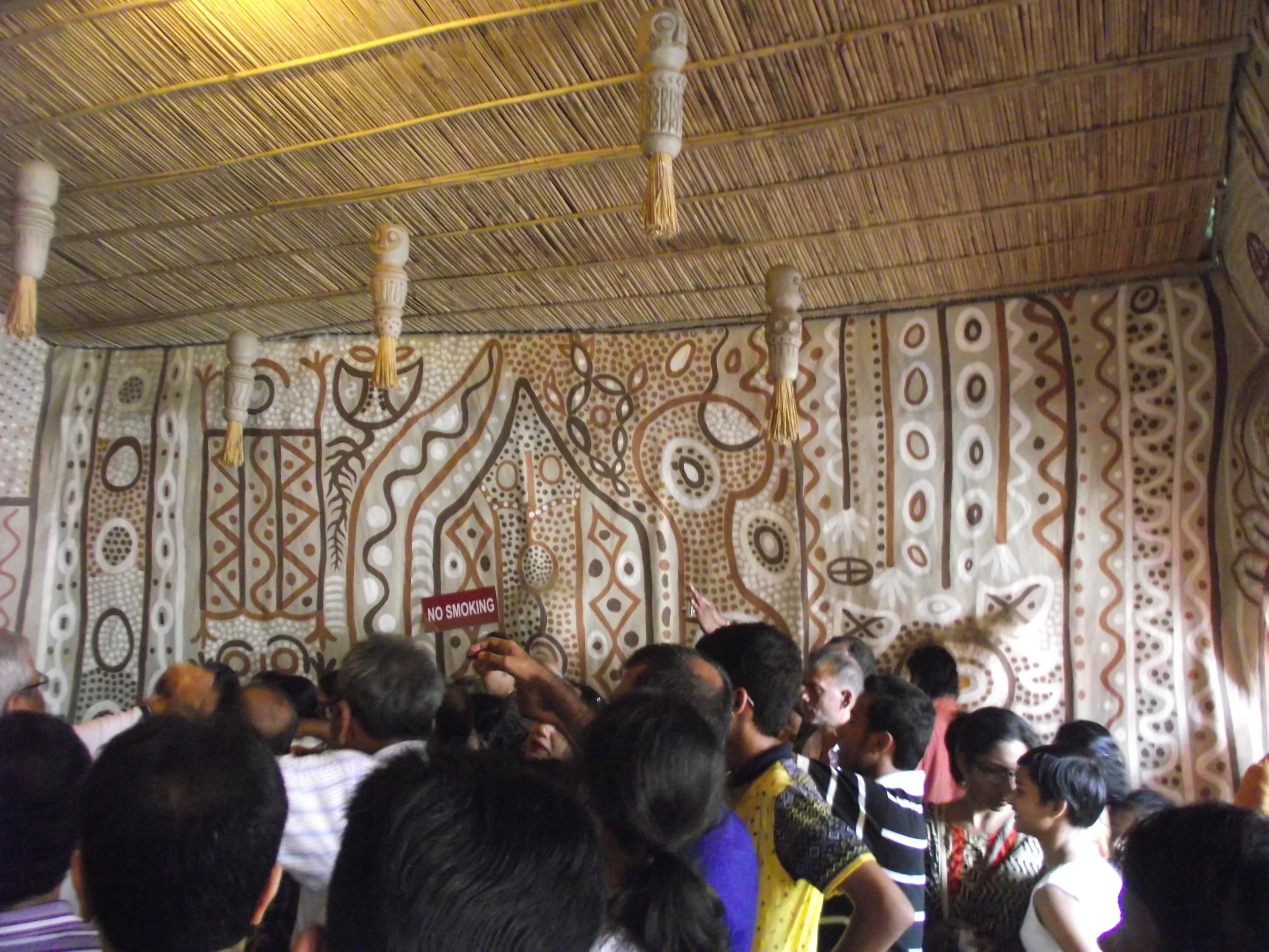  Dedication and prayers on the occassion of mahaashtami. Notice the wall painted in the style of cave paintings. 