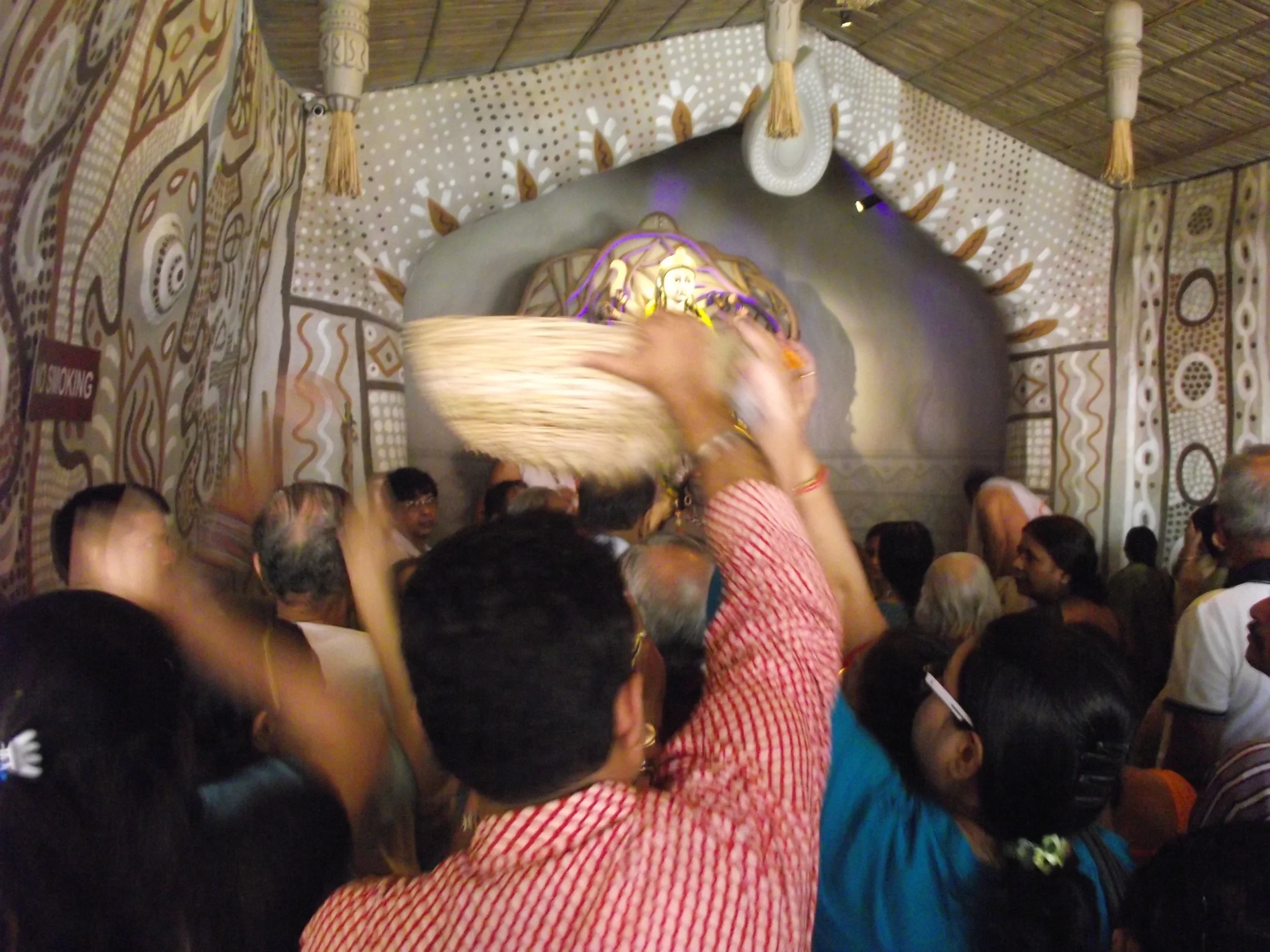  After the  pushpanjali  people do not throw the flowers. Its collected in the basket and then the basket of flowers offered to Durga's footsteps. 