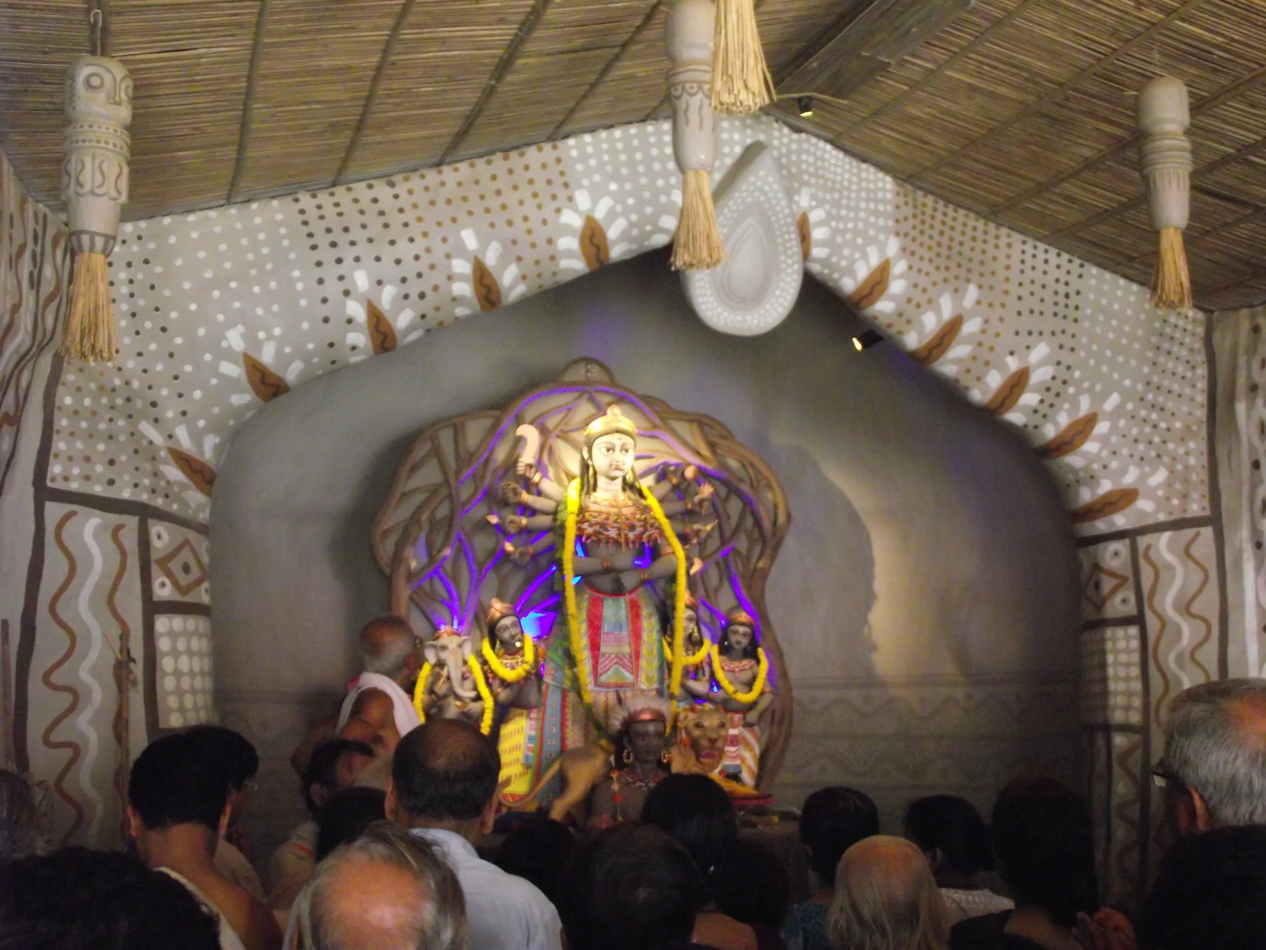  The  pushpanjali  happens in 4 rounds. This is the final round when people offer the final prayer. In the final round they do not use flowers. Its prayer offered with folded hands. 