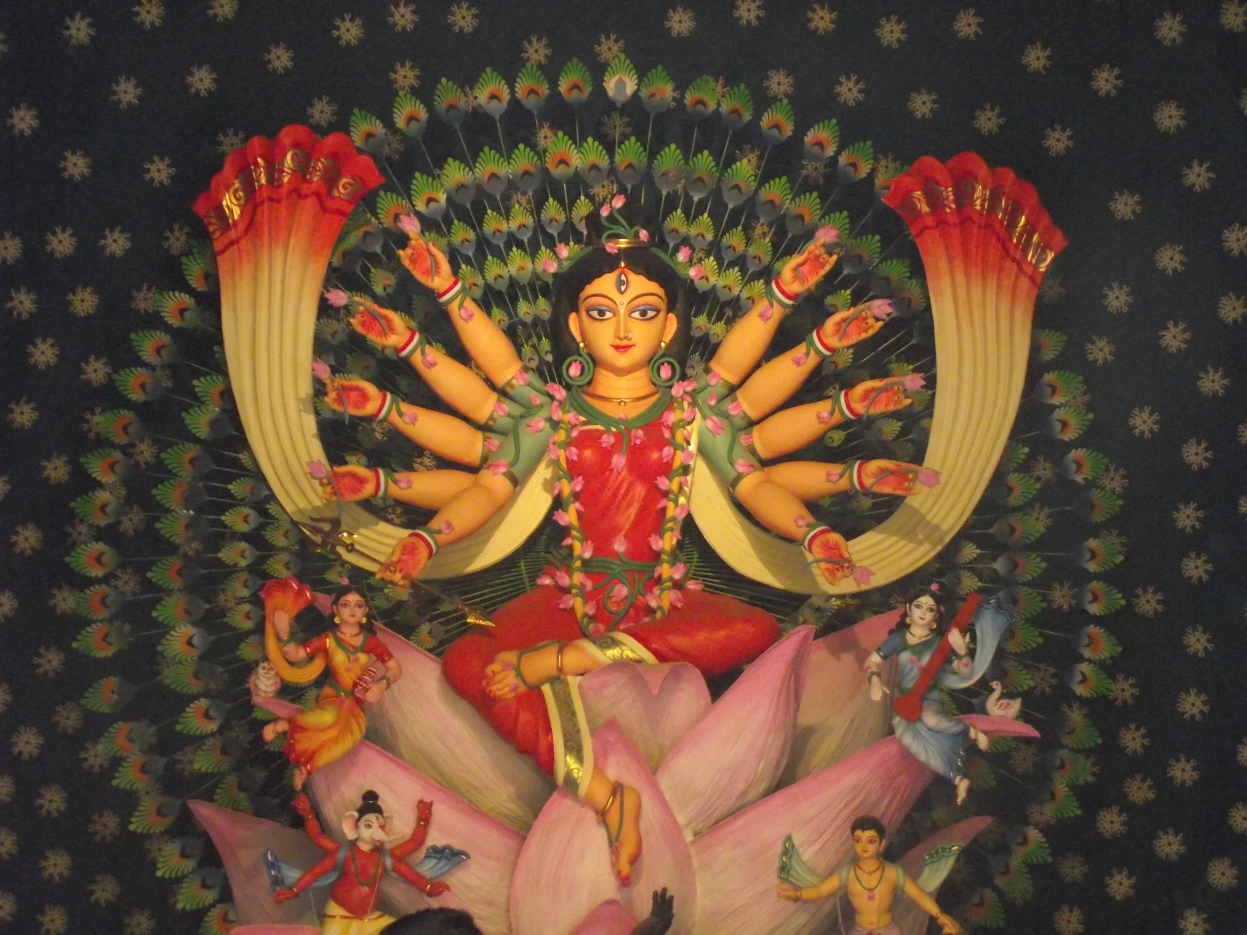  Goddess Durga is also among the blooming shiulis (species of  Nyctanthes)&nbsp; and lotus, resonating with life in this bright sunny world. 