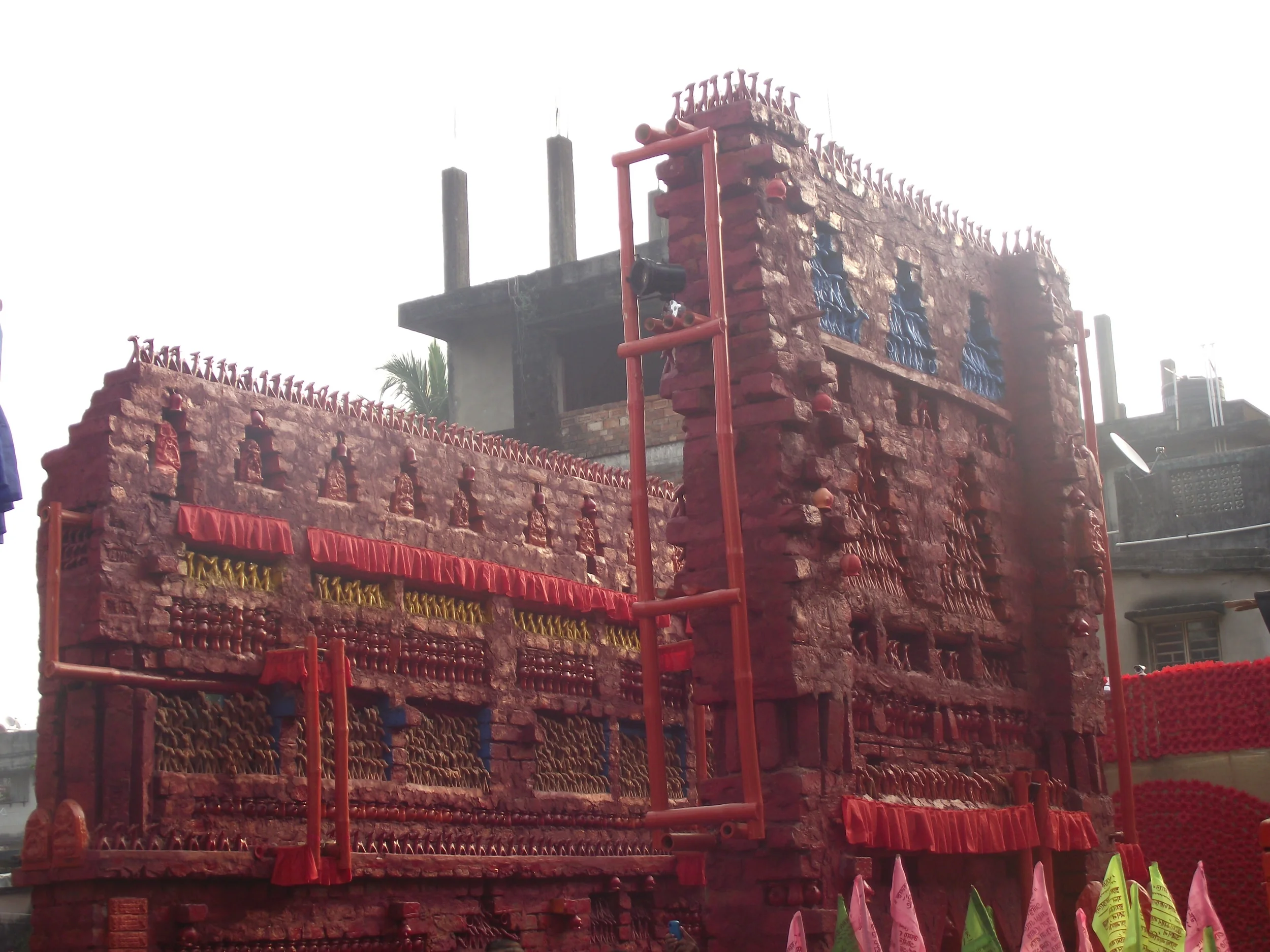  Main entrance of the pandal. The building blocks of the pandal were made of bricks and clay dolls / terracotta dolls were arranged across the structure. 