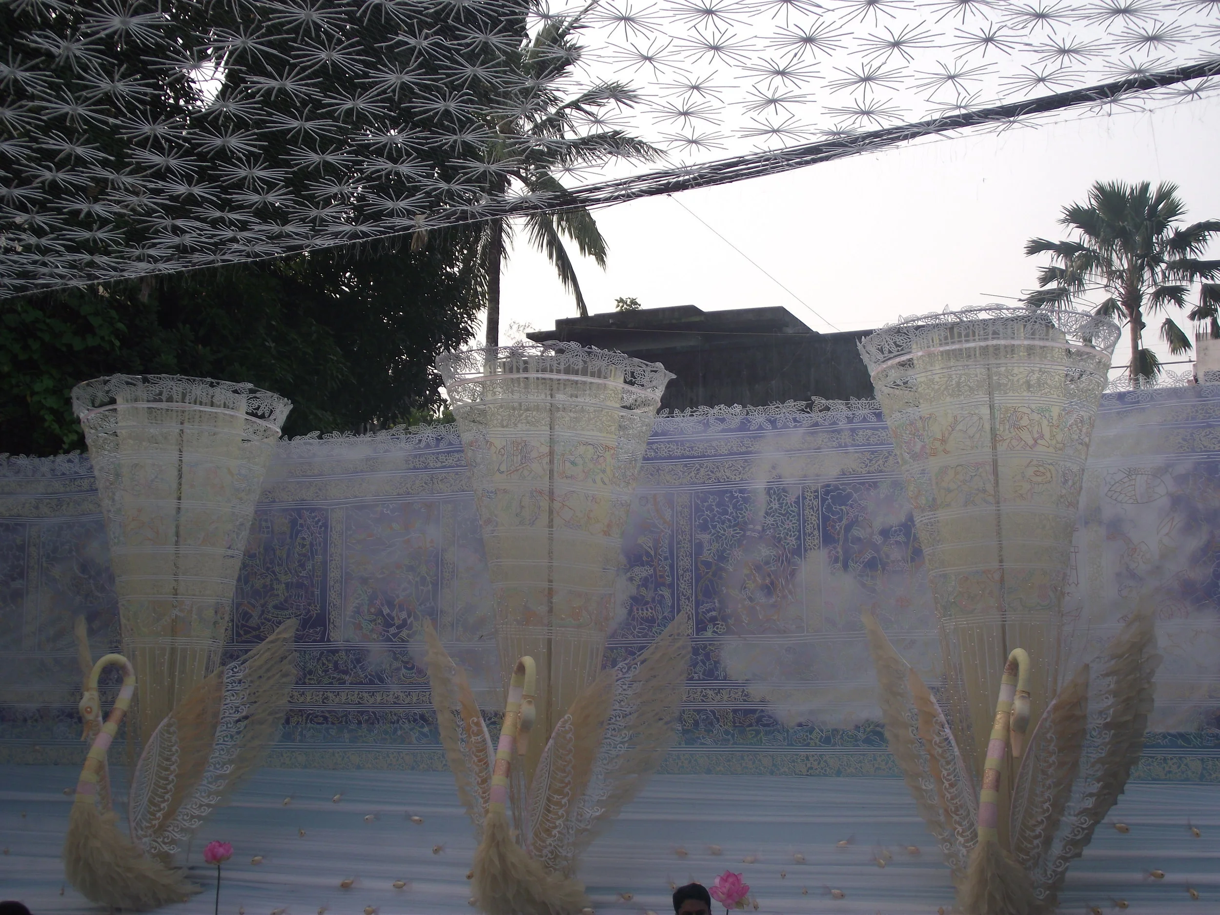  Observe the depiction of swarm of fishes and the line of swans sailing in the waters... 