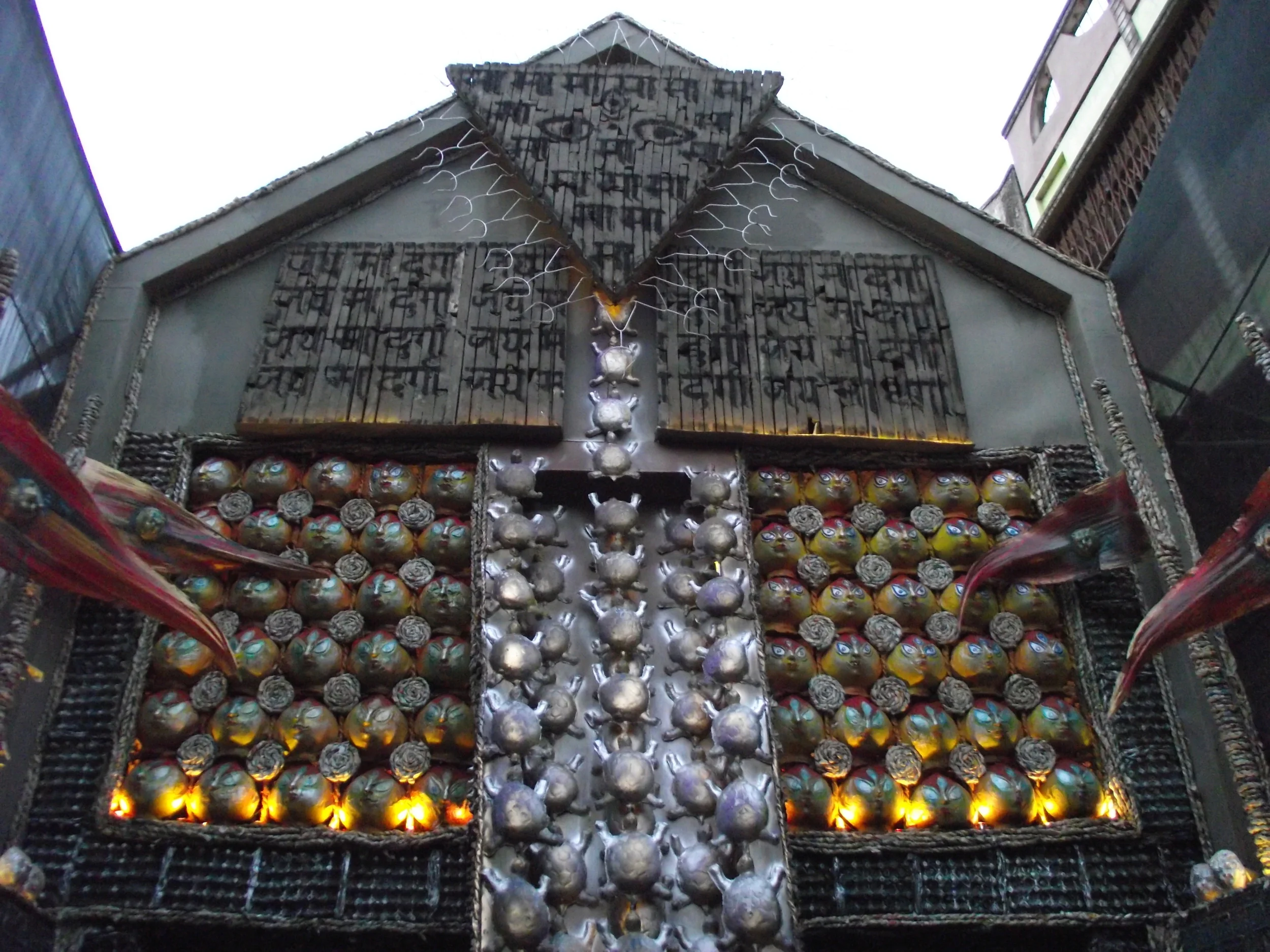  Entry gate of the pandal having different forms of papier-mache masks. 