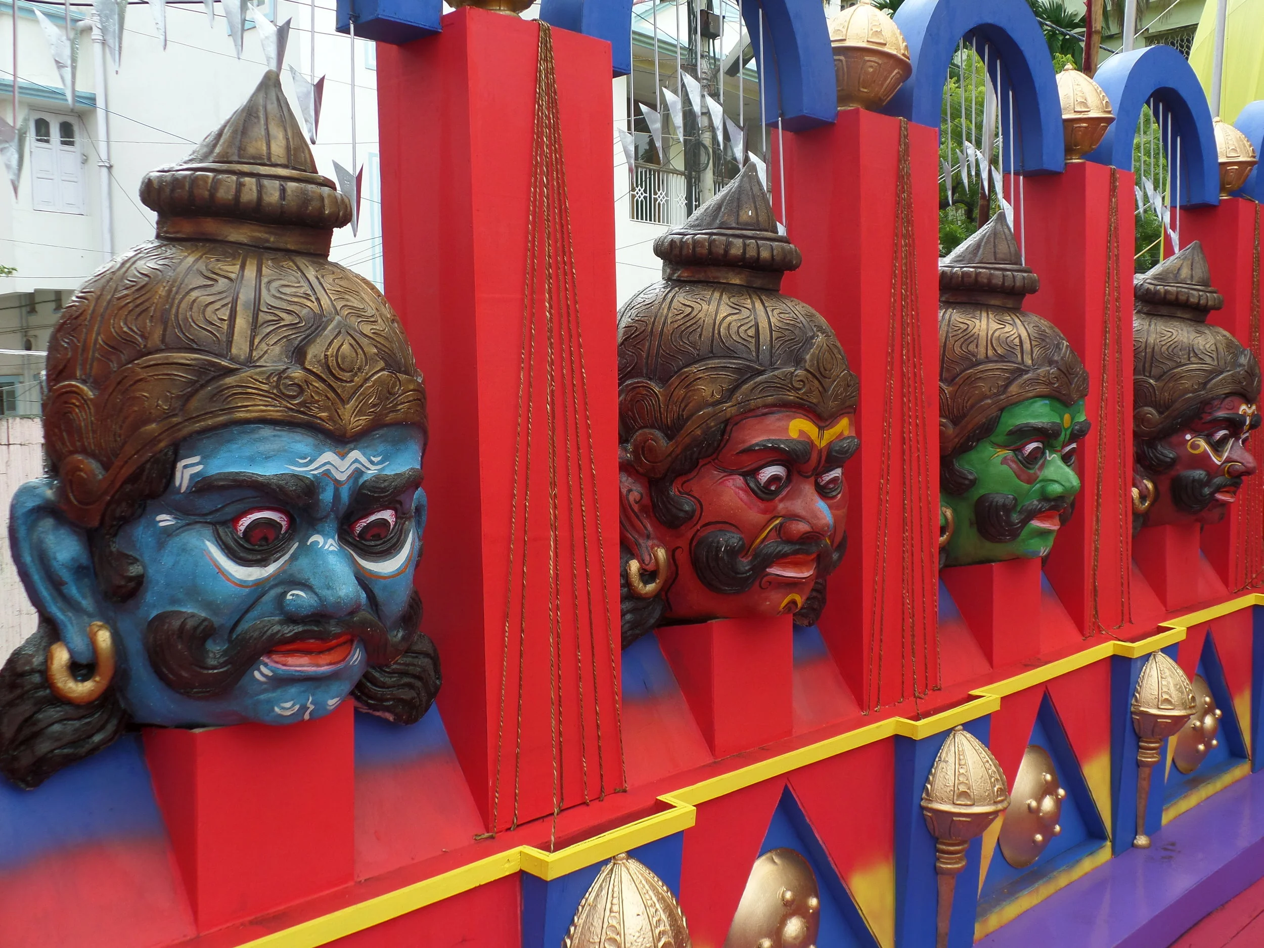  Images depicting  asura  in different colours surrounding the circumference of the pandal. 