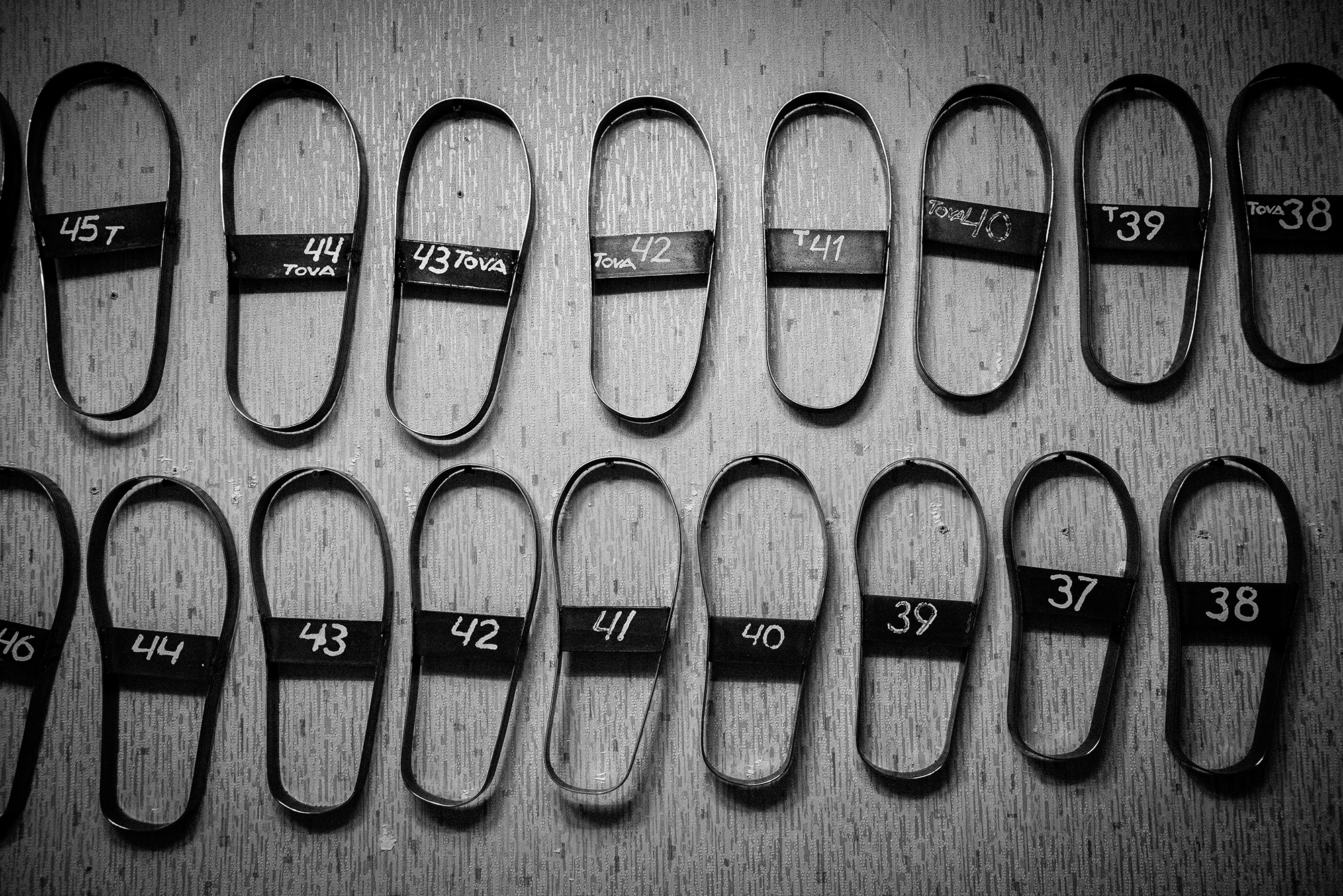 Moulds in different shoe sizes, used to cut the leather soles for Tova’s slippers.