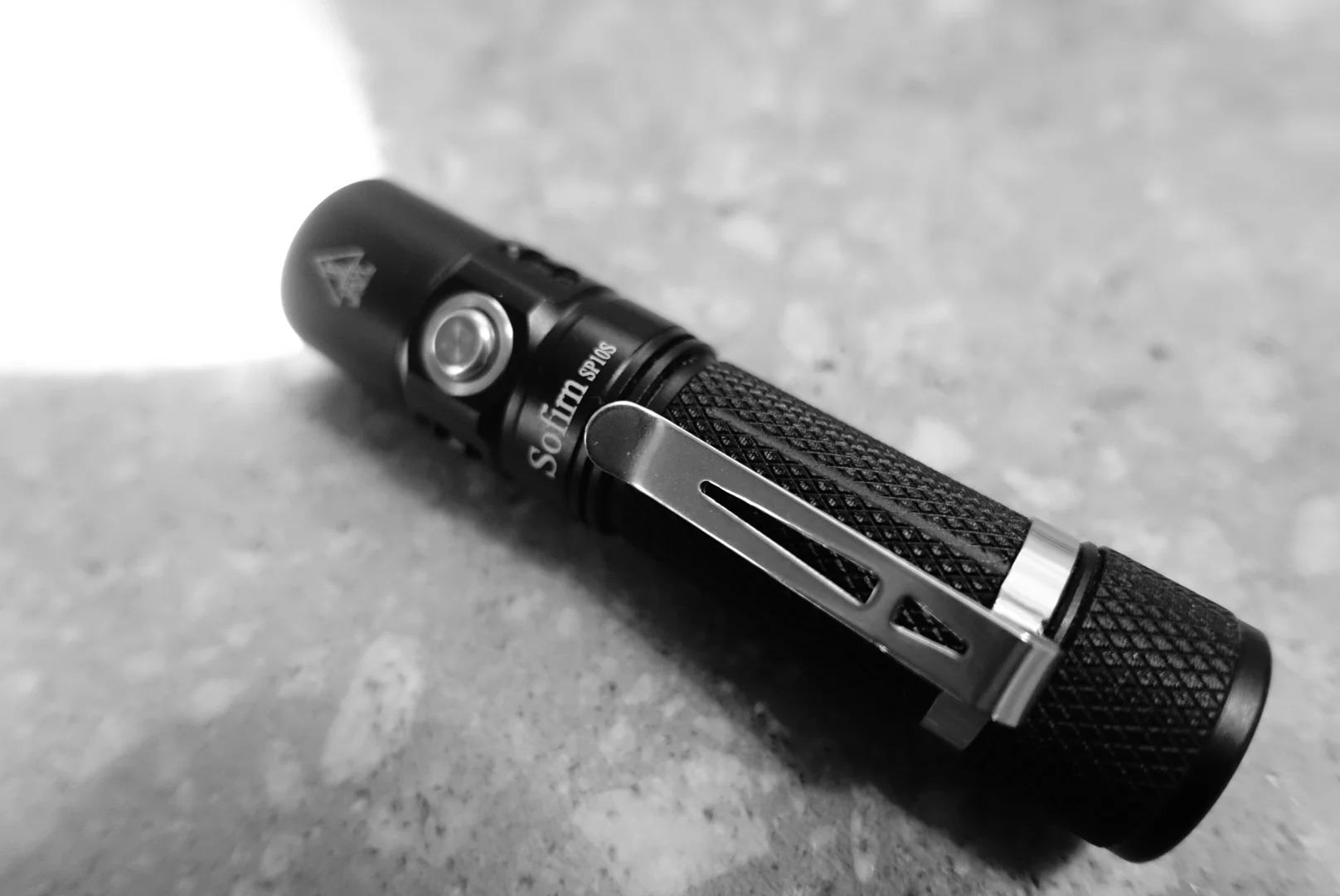 Sofirm SP10S, set on high-300 lumen, photographed against a raw concrete countertop.