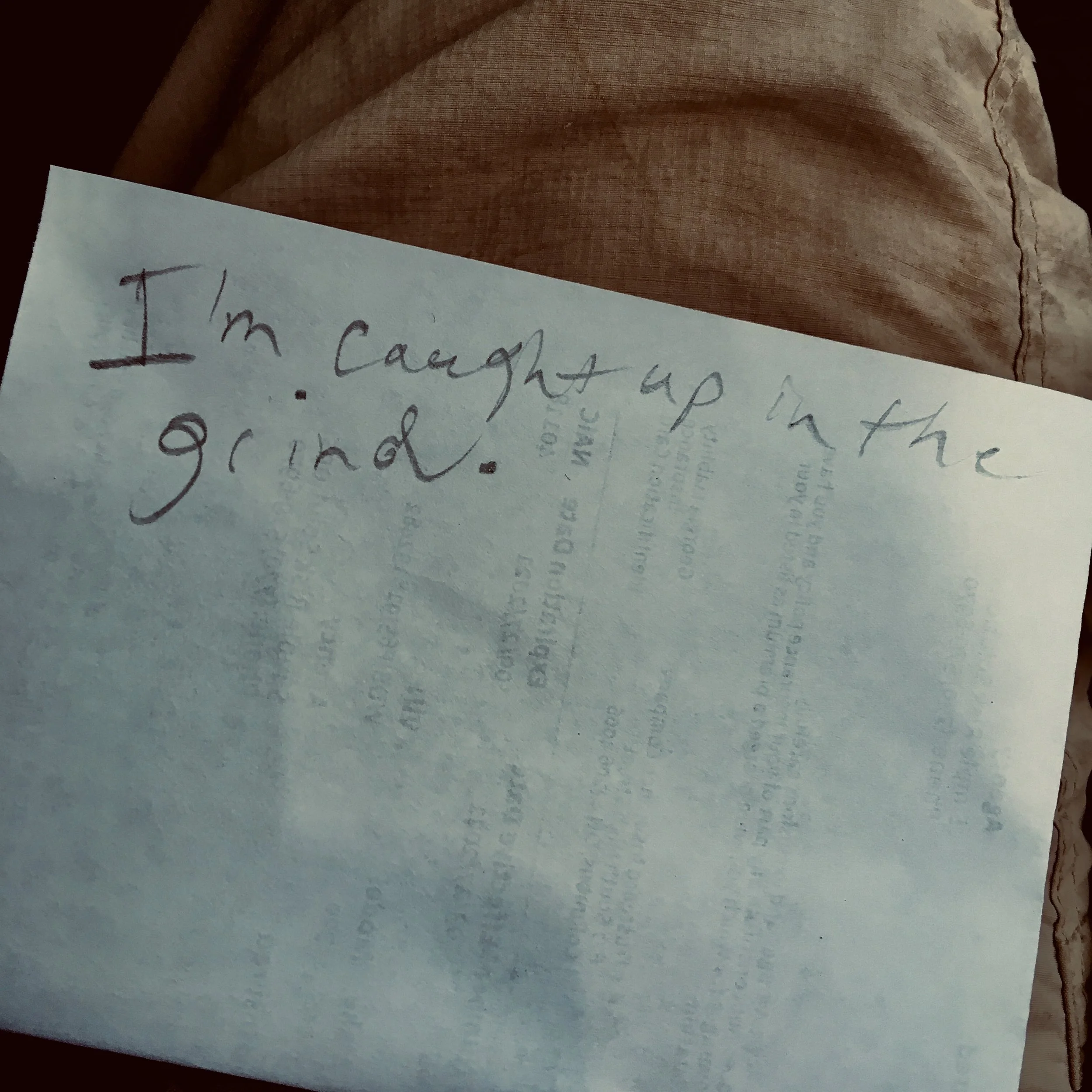 hand written note resting on someones thigh.
