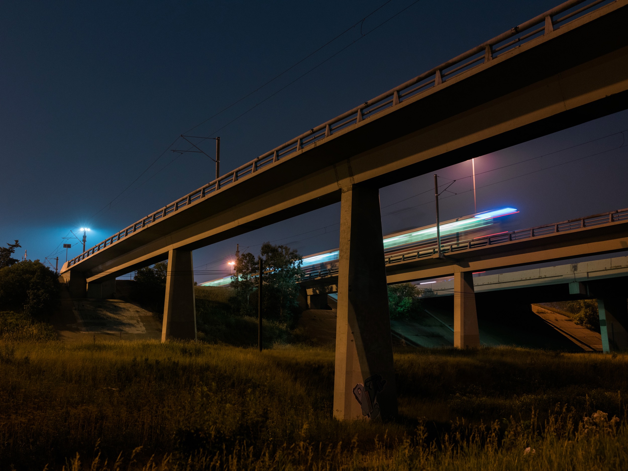 I set out to take photos of the highway from an overpass but found trains instead. I brought my tripod along so I could try shooting at night with low ISOs. Using a tripod made me much more intentionaI about the photographs.