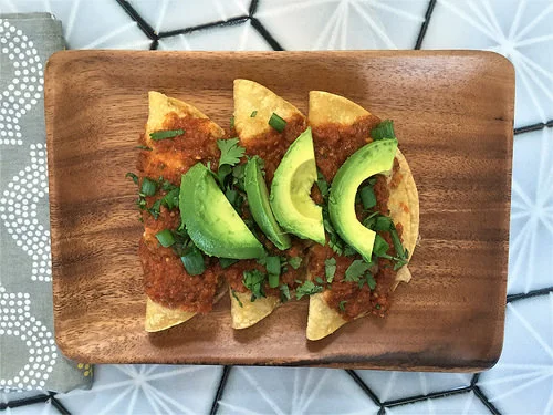 polenta and black bean enchiladas with tomato sauce and avocado plate.jpg