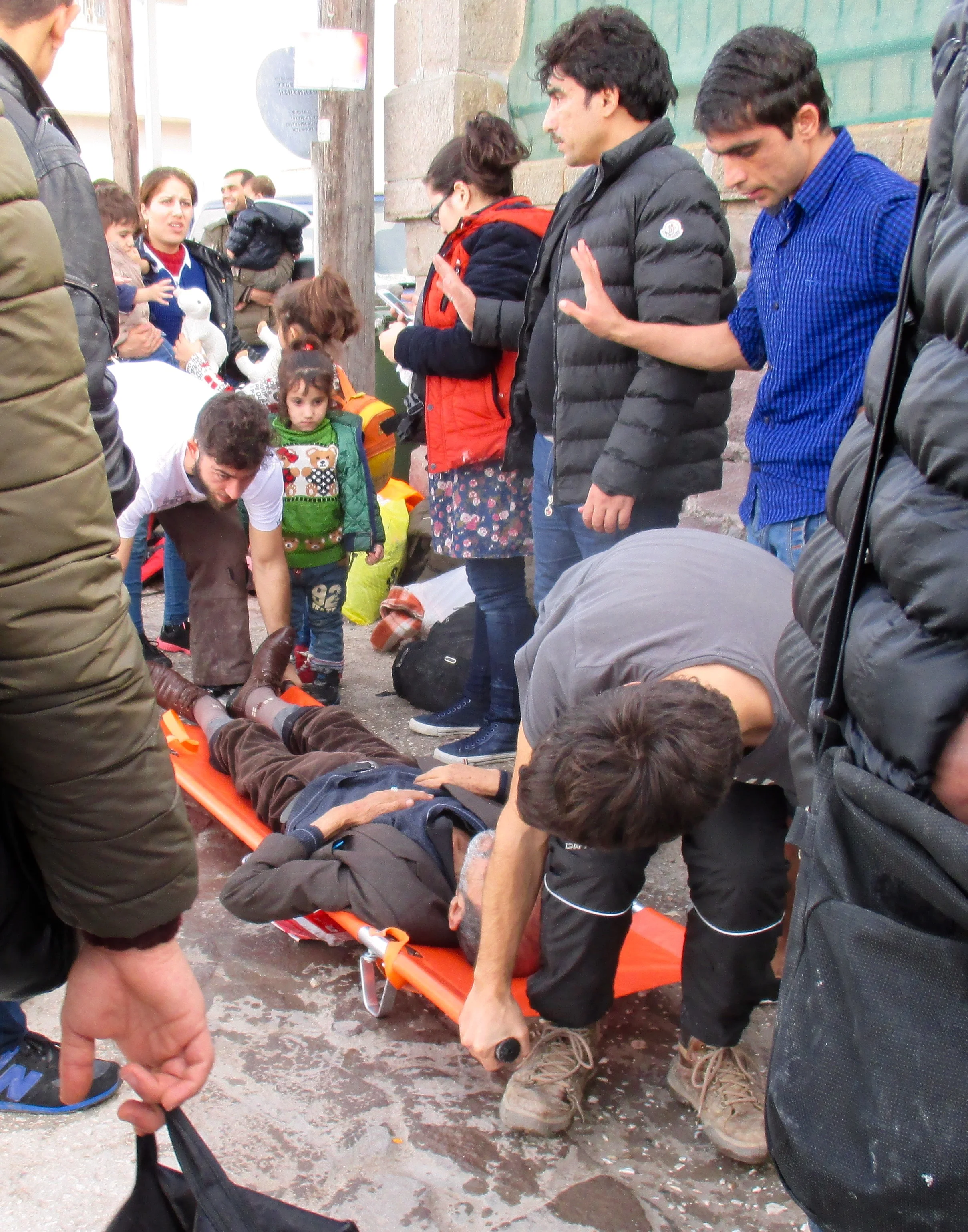 An elderly man arriving on Lesvos is taken by volunteers to receive medical care.