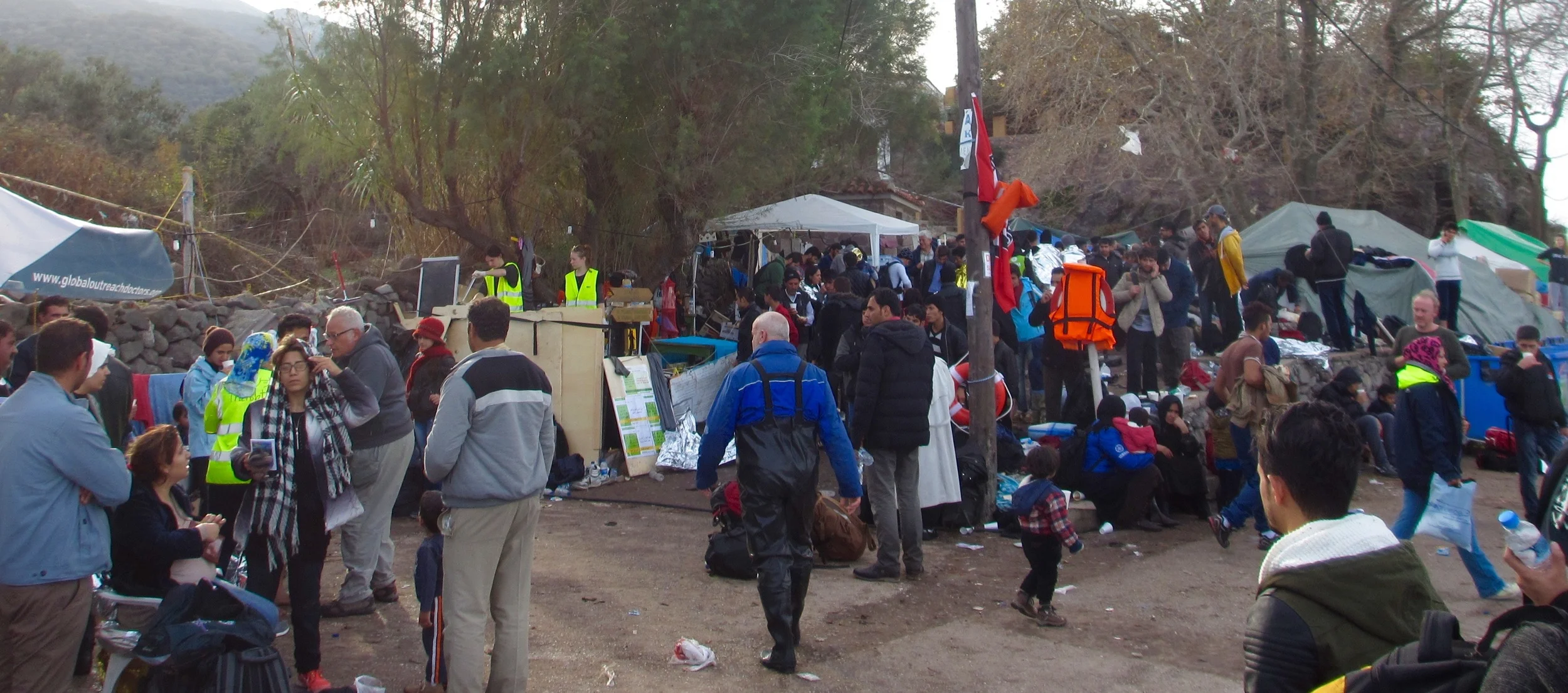 Refugees receive hot broth and a change of clothes and shoes.