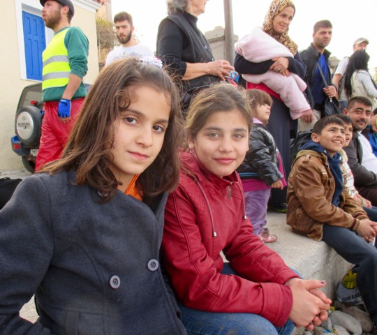 Two young Syrian girls rest before walking to the transit center in Lesvos.