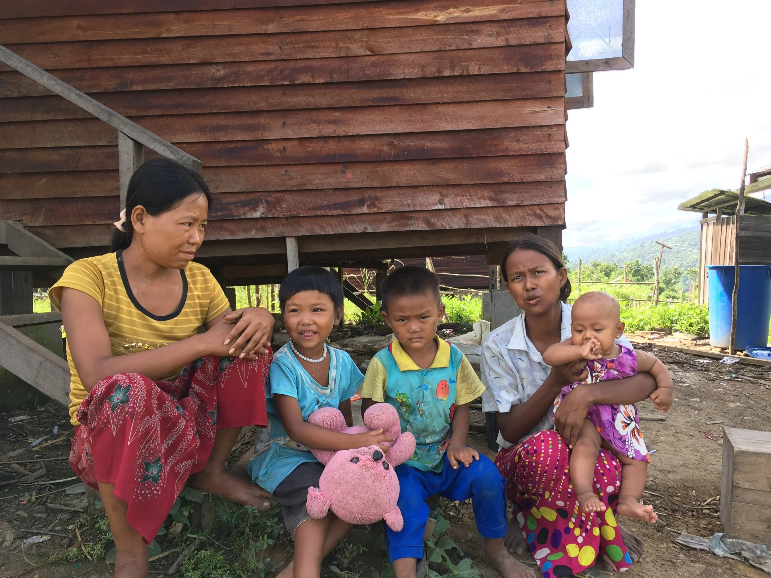 When RI visited this area of Sagaing Region in September 2015, these families were living in tents along a roadside, their homes having been washed away by flash floods. Now, one year later, they have been relocated away from the river to government-owned land and are living in new homes built with support from international donors. They feel safer in their new homes, but the new site is situated along a steep mountainside far from the main road, creating numerous challenges.