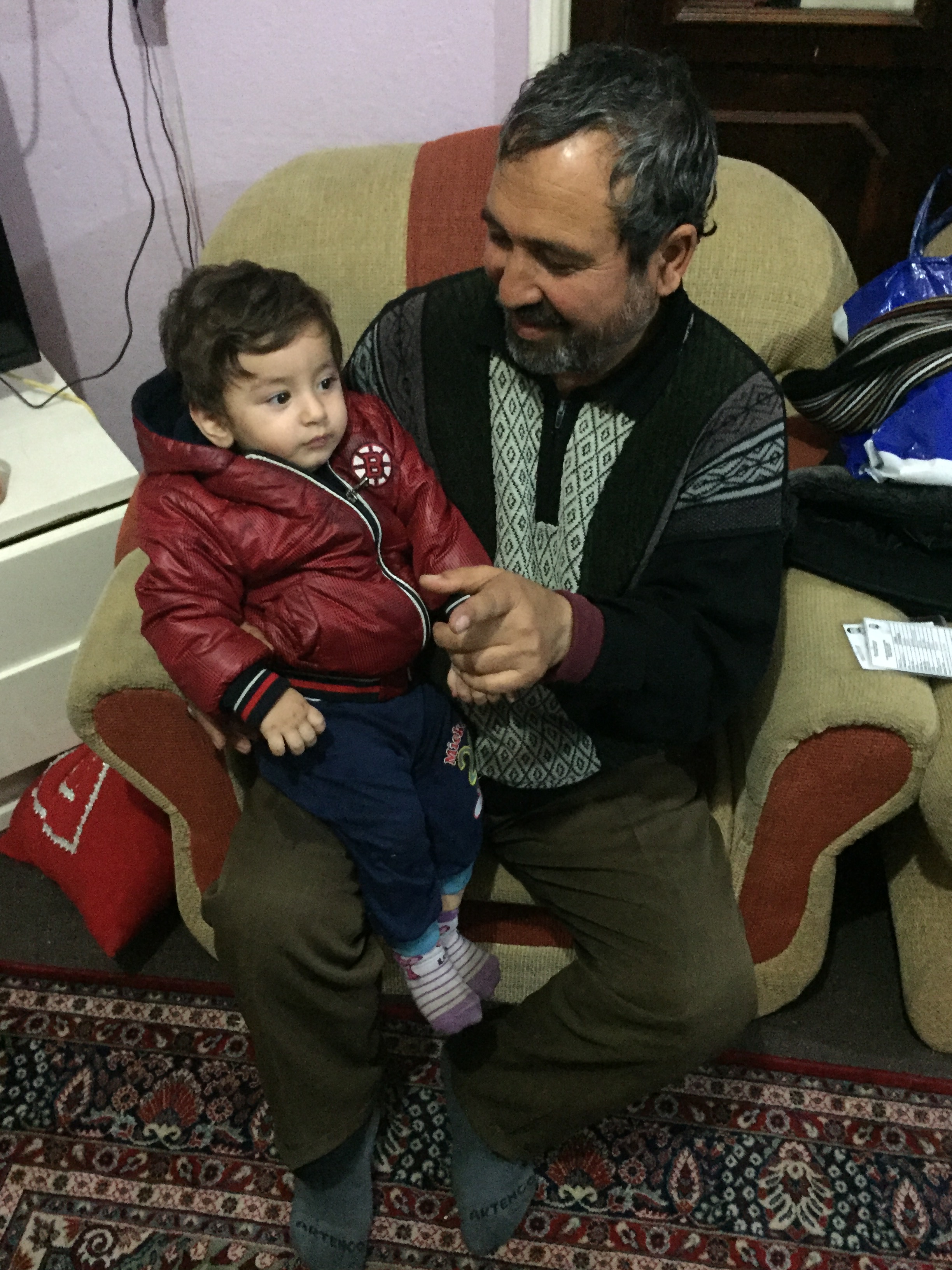 Ali, a 48-year-old Afghan asylum-seeker with his grandson in Kayseri, Turkey.