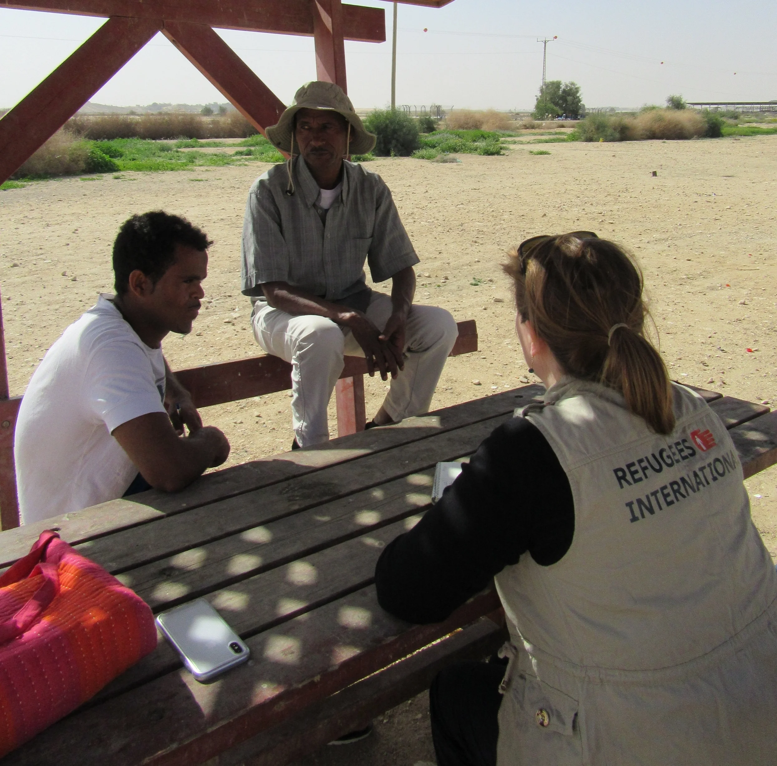RI staff member interviewing asylum seekers near the Holot Detention Center